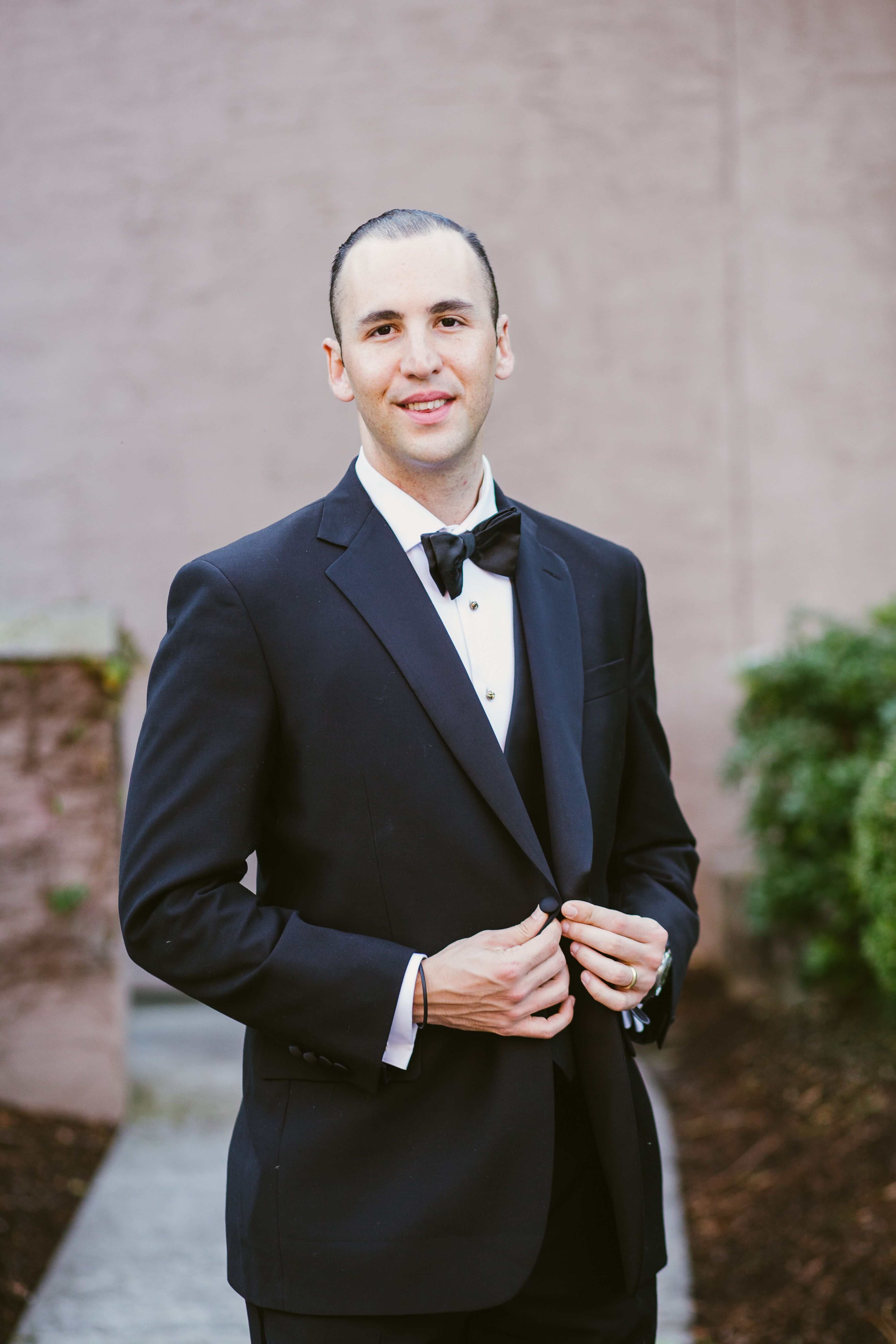 Groom Dressed in a Classic Black Tuxedo with Bowtie