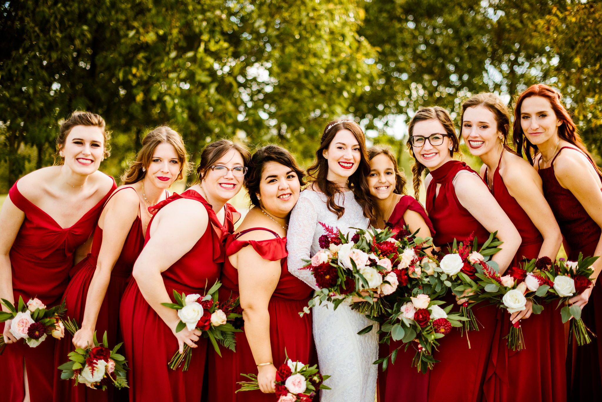 Modern Bridesmaids with Red Gowns and Bouquets