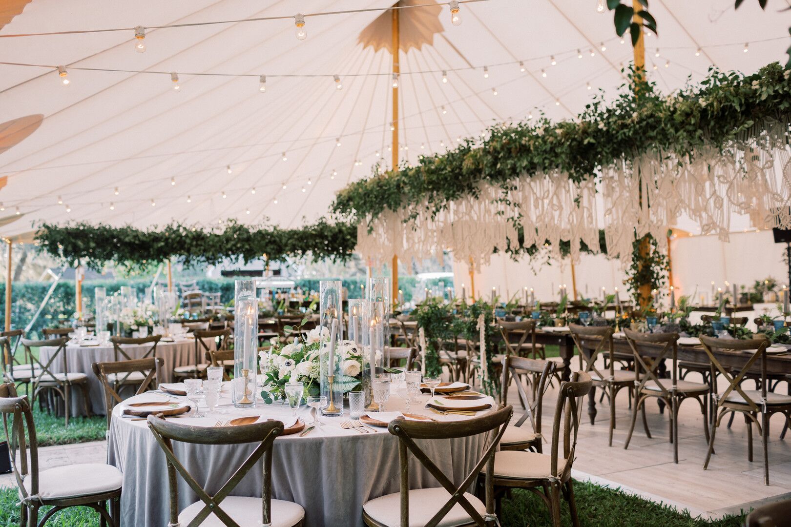 Tented Reception with String Lights, Hanging Greenery and Dining Tables