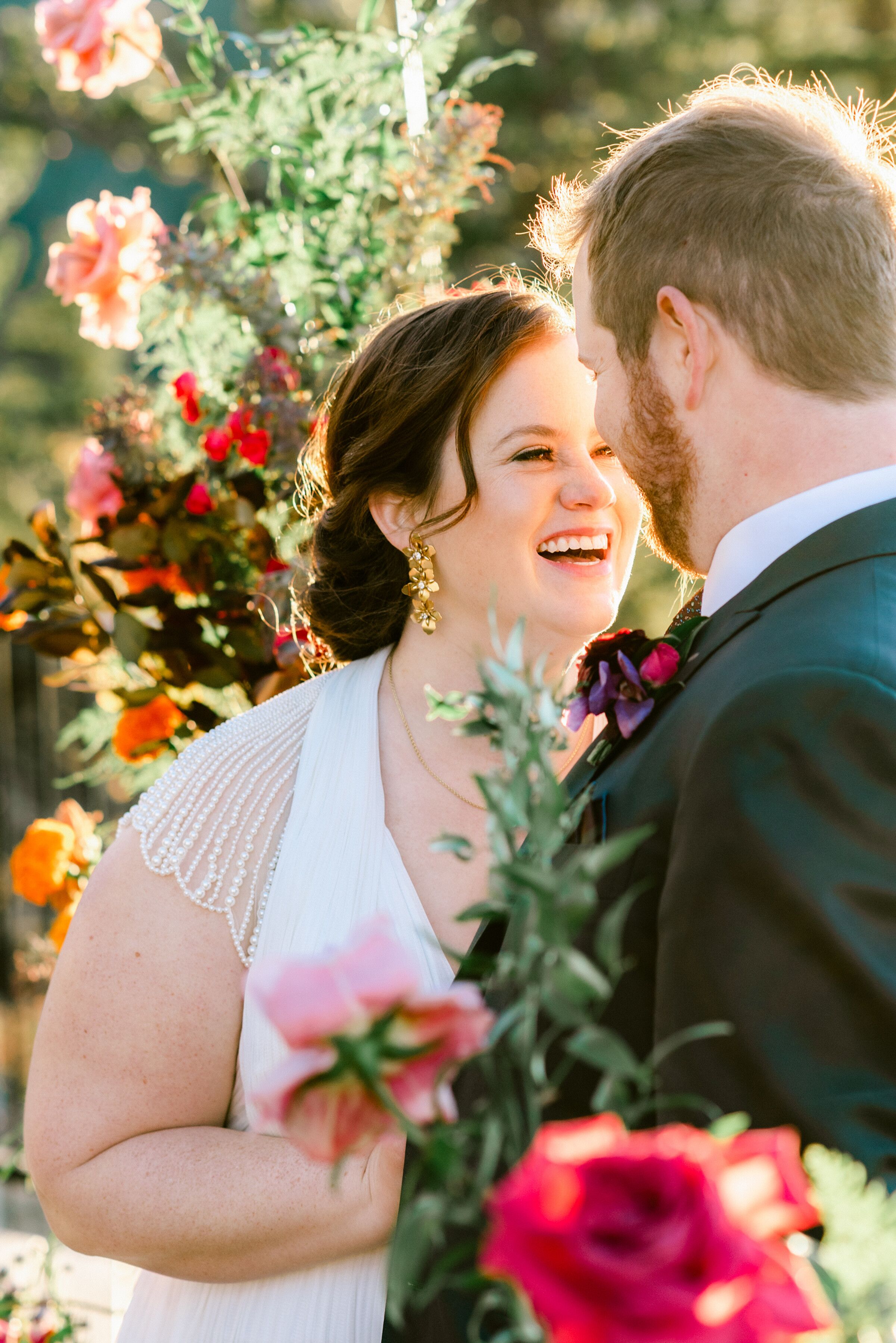 Bride With Updo and Gold Earrings Laughing