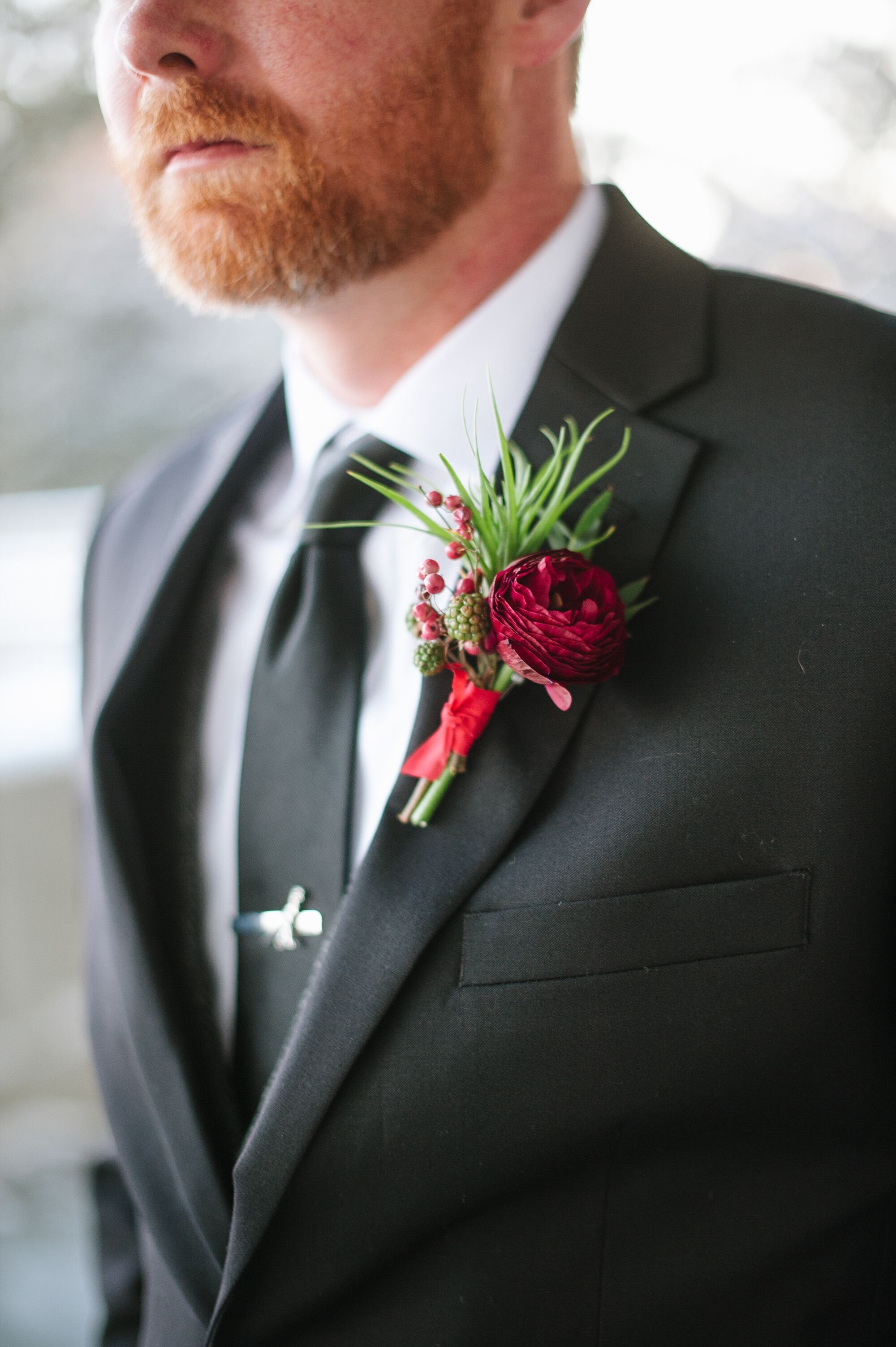Burgundy Ranunculus and Raspberry Boutonniere