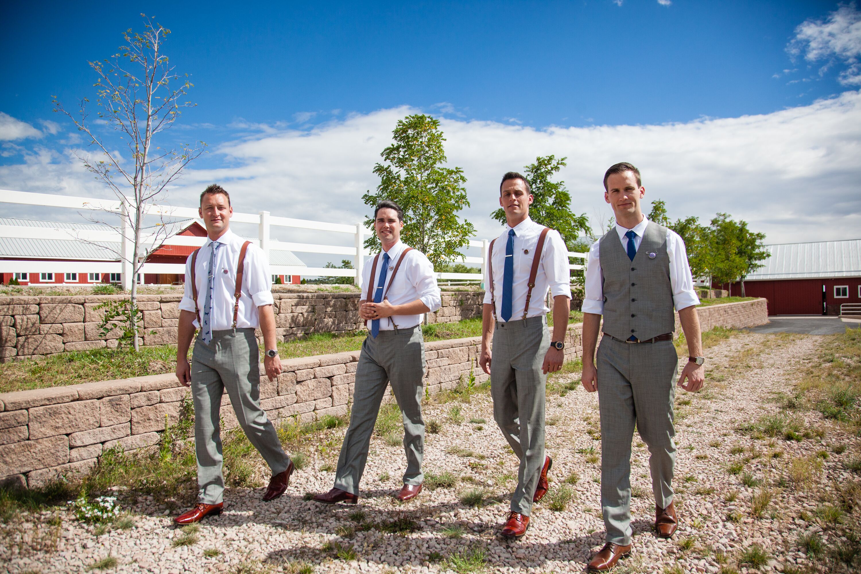 Groomsmen in Gray Pants with Brown Suspenders and Navy Ties