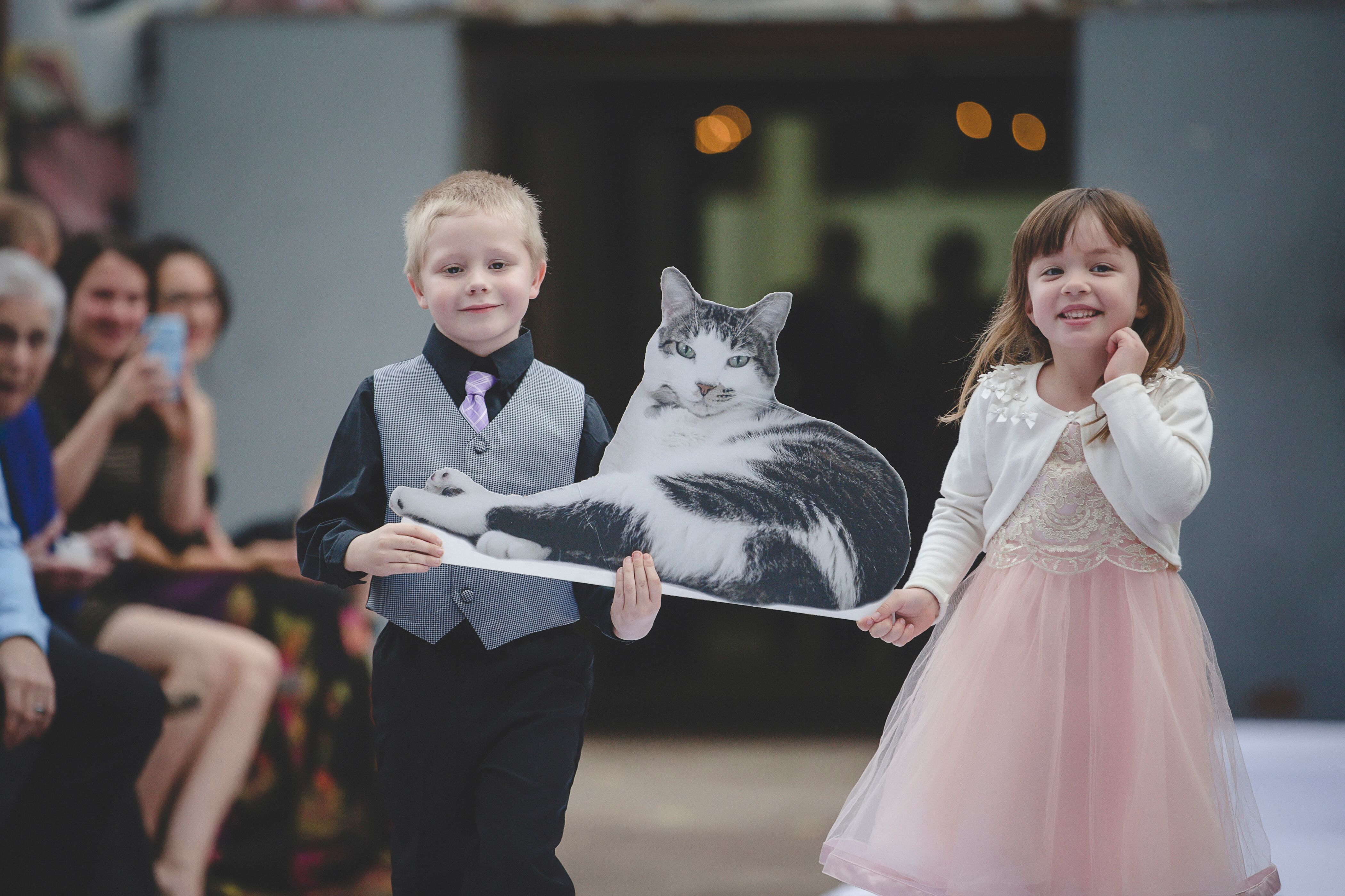 Groom's Relatives Carry Cat Cutout Down Aisle