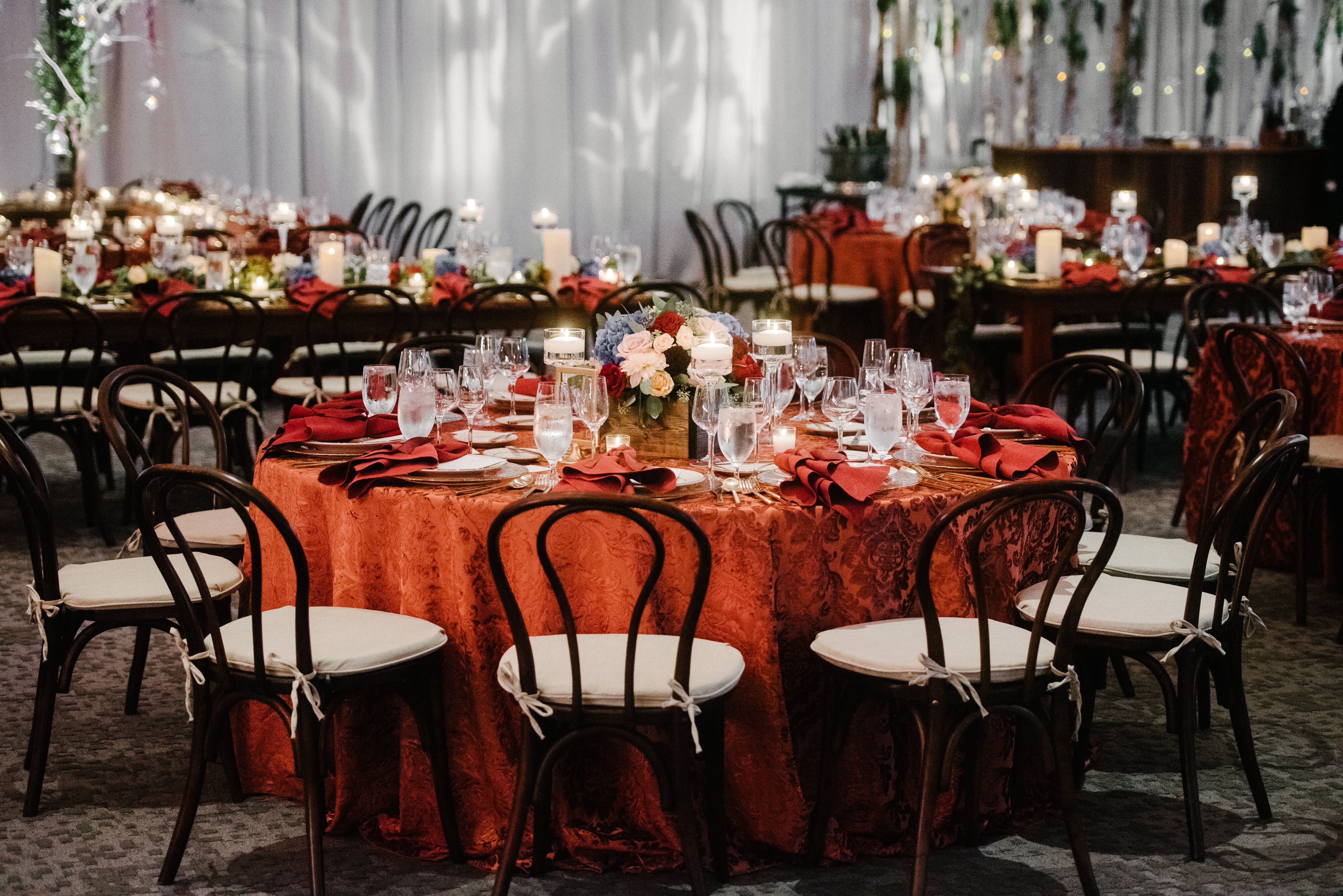 Orange Tablecloth and Wood Sweetheart Chairs