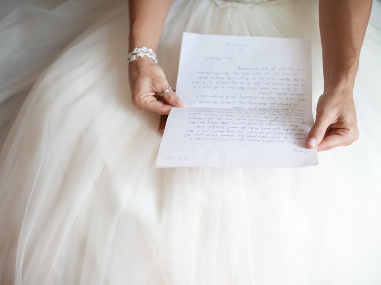 Bride reading groom's note before ceremony