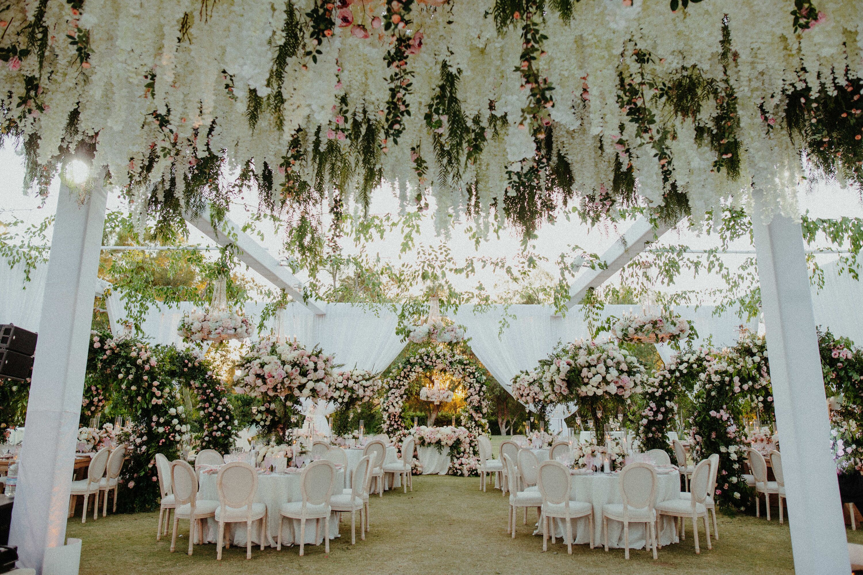 Long White Flowers, Hanging Installation Over Whimsical Floral Garden 