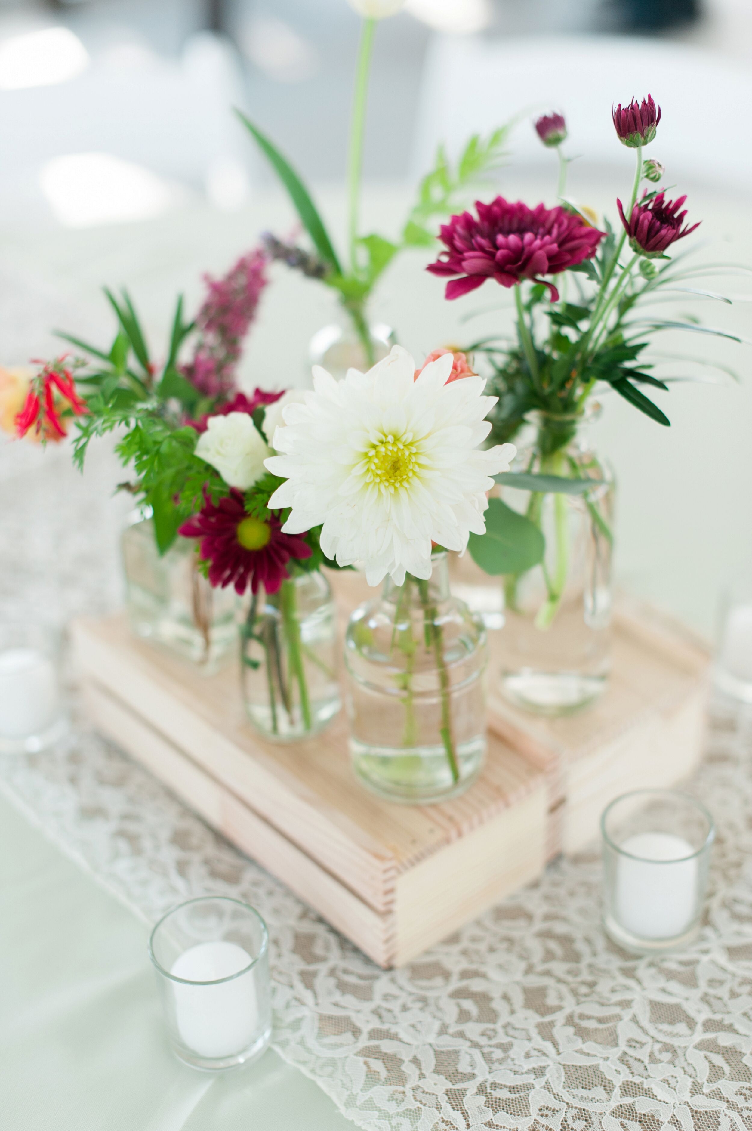 Assortment of Glass Vase Flower Arrangements on Wood Crates