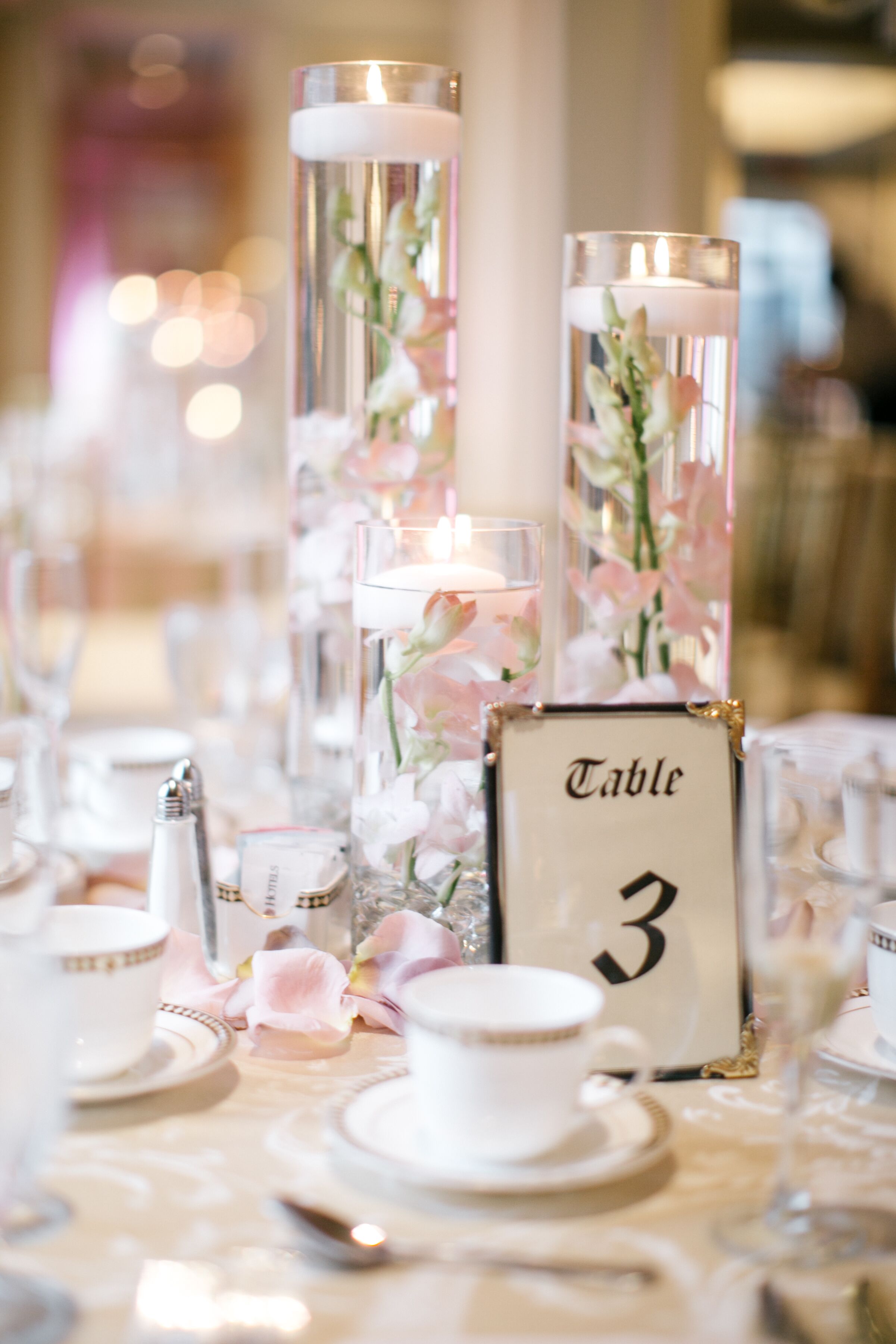 Floating Candle Centerpieces with Blush Orchids and Rose Gold Table Linens