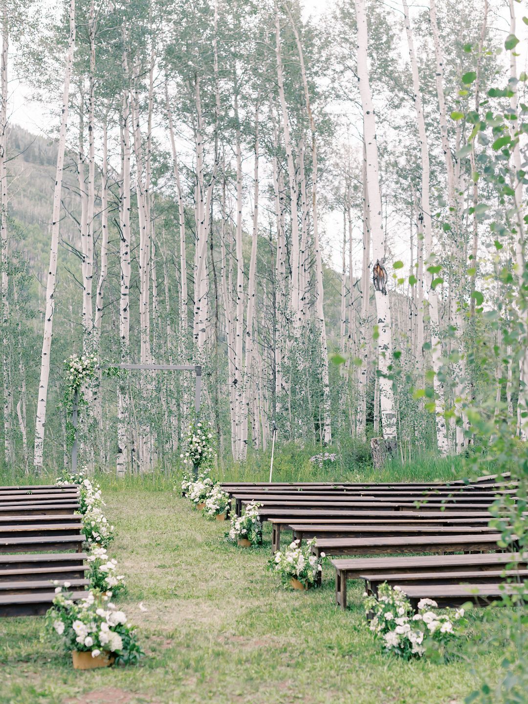 Bench Ceremony Seating at Ranch in Colorado With Simple Flowers and Aspens