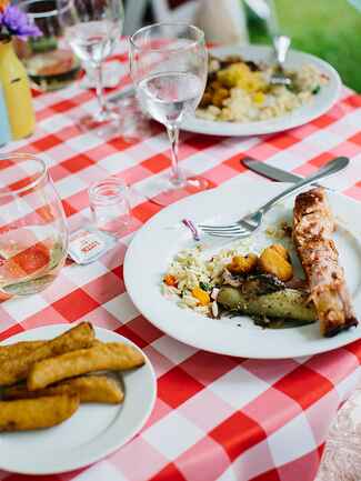 Red picnic table linens for a BBQ wedding reception