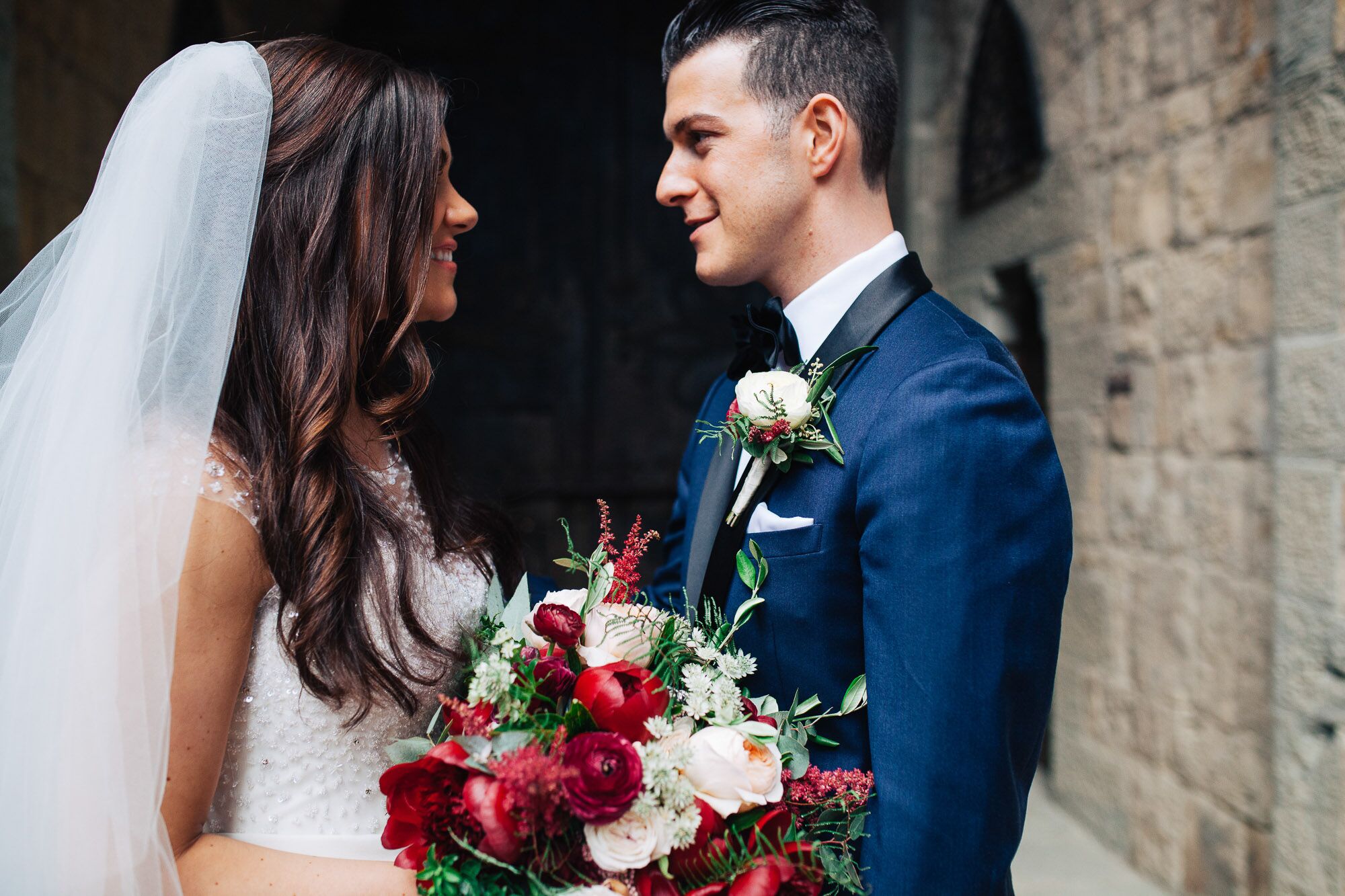 Olive Leaf and Ranunculus Boutonniere With Burgundy Splash