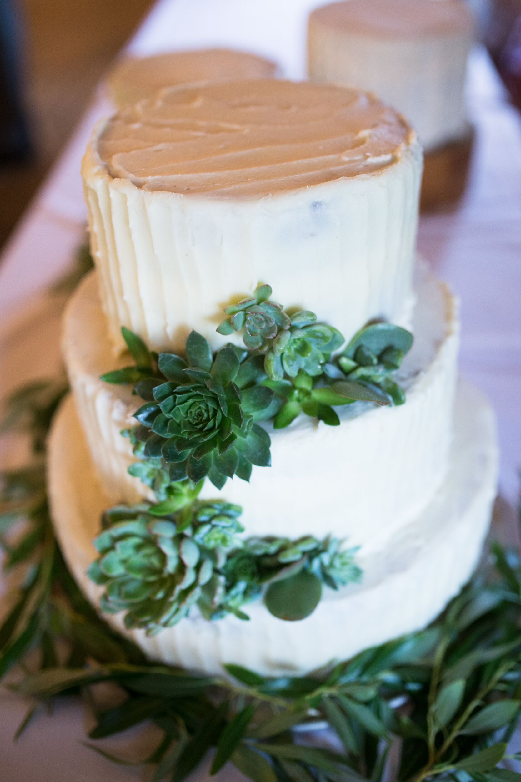 Green Succulent-Decorated White Buttercream Wedding Cake