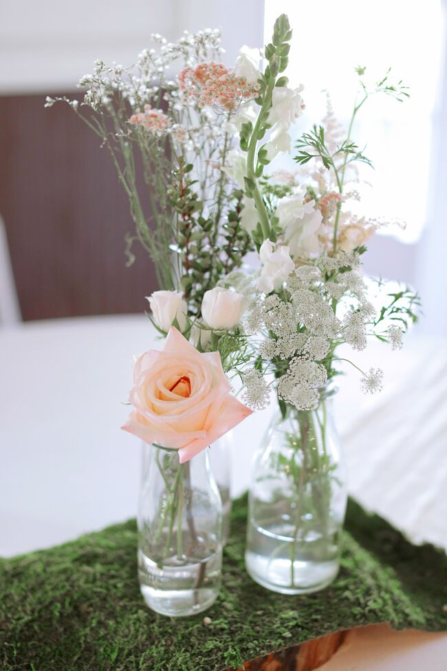 Simple Bottle Centerpiece With Roses on Moss