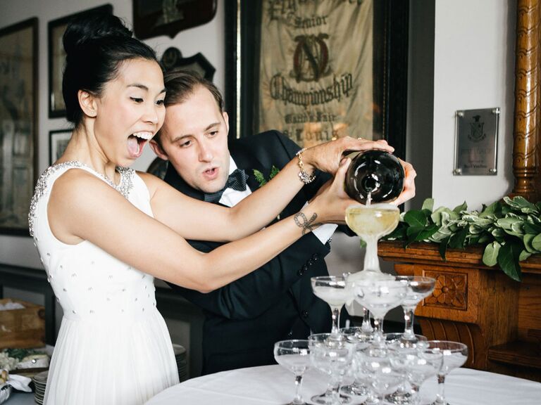 Bride and groom pouring champagne tower