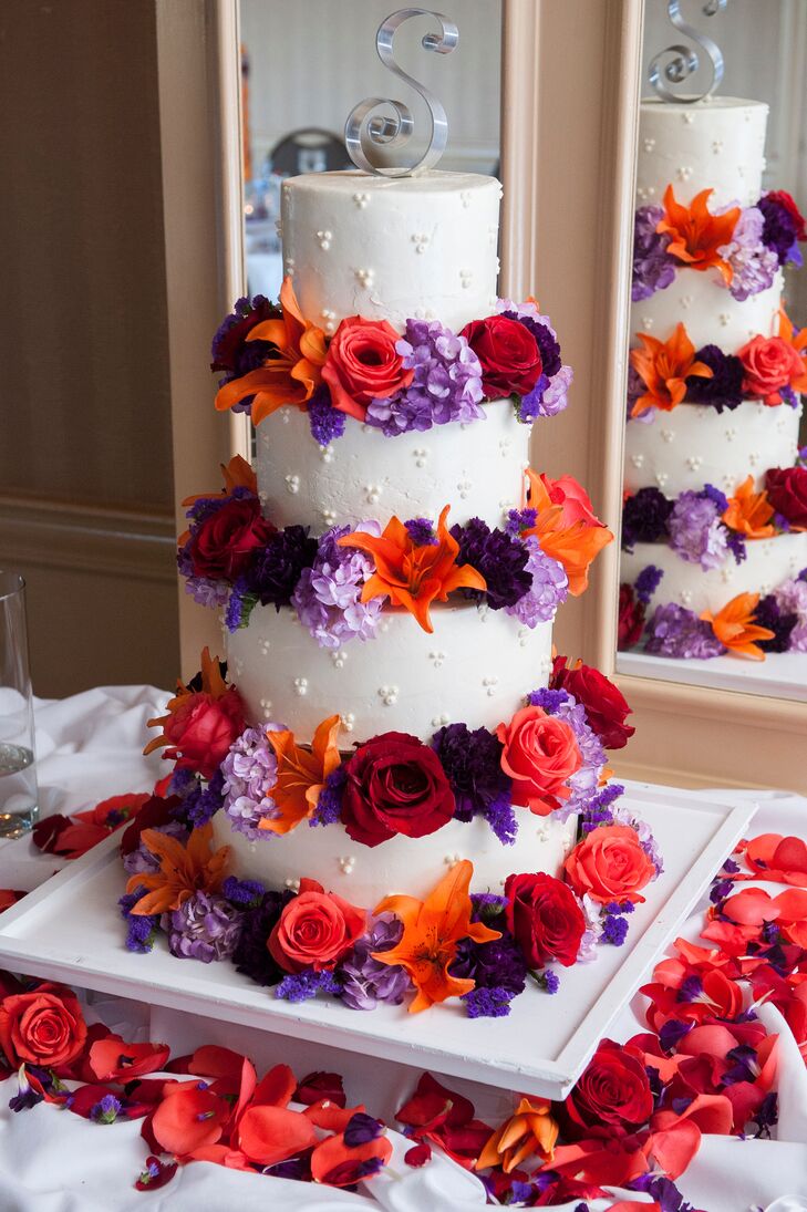 FourTier Wedding Cake with Bright Red and Purple Flowers