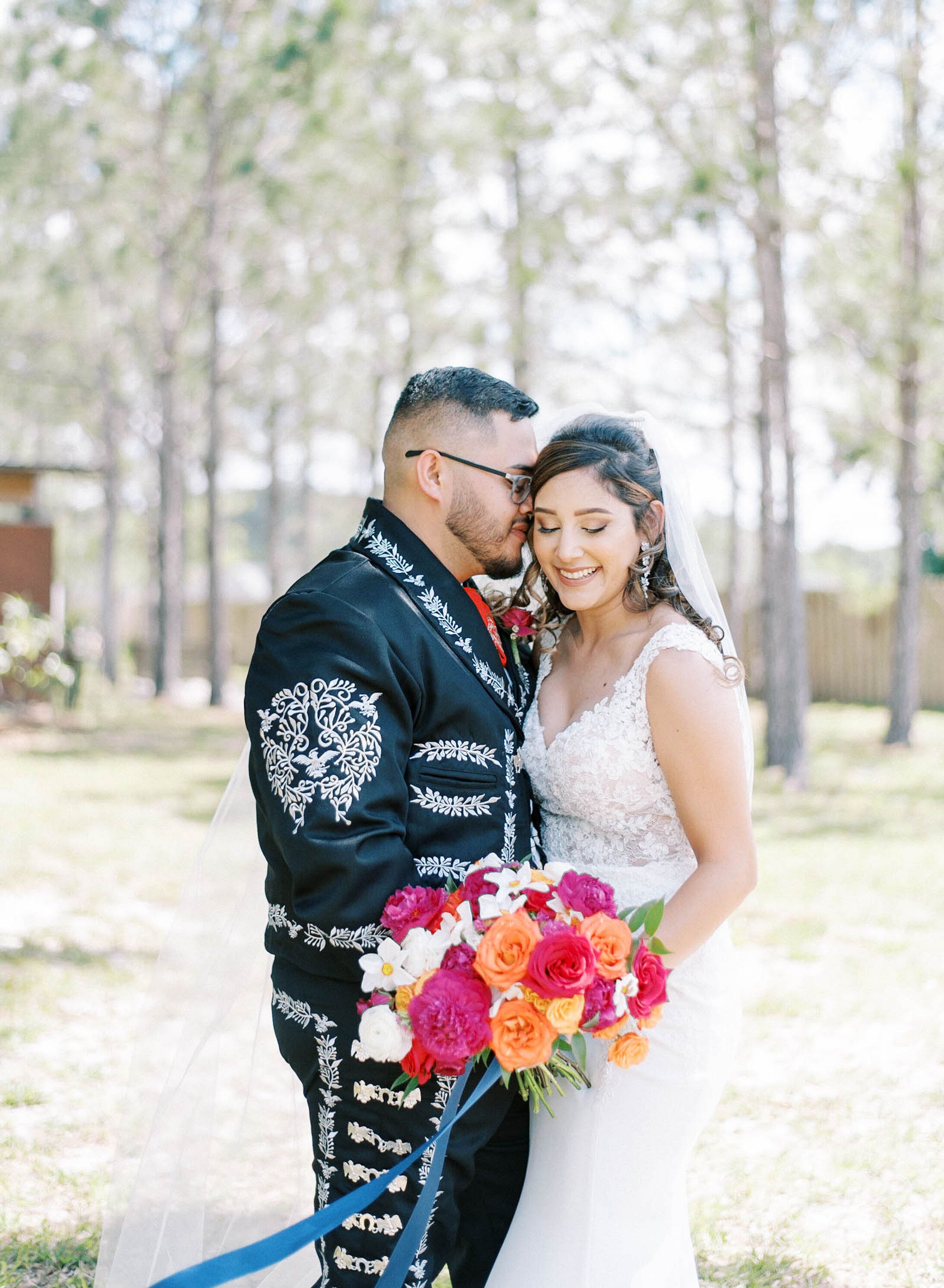 Groom in Mexican-Inspired Suit Hugging Bride