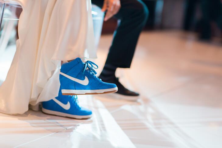 bride wearing blue wedge sneakers