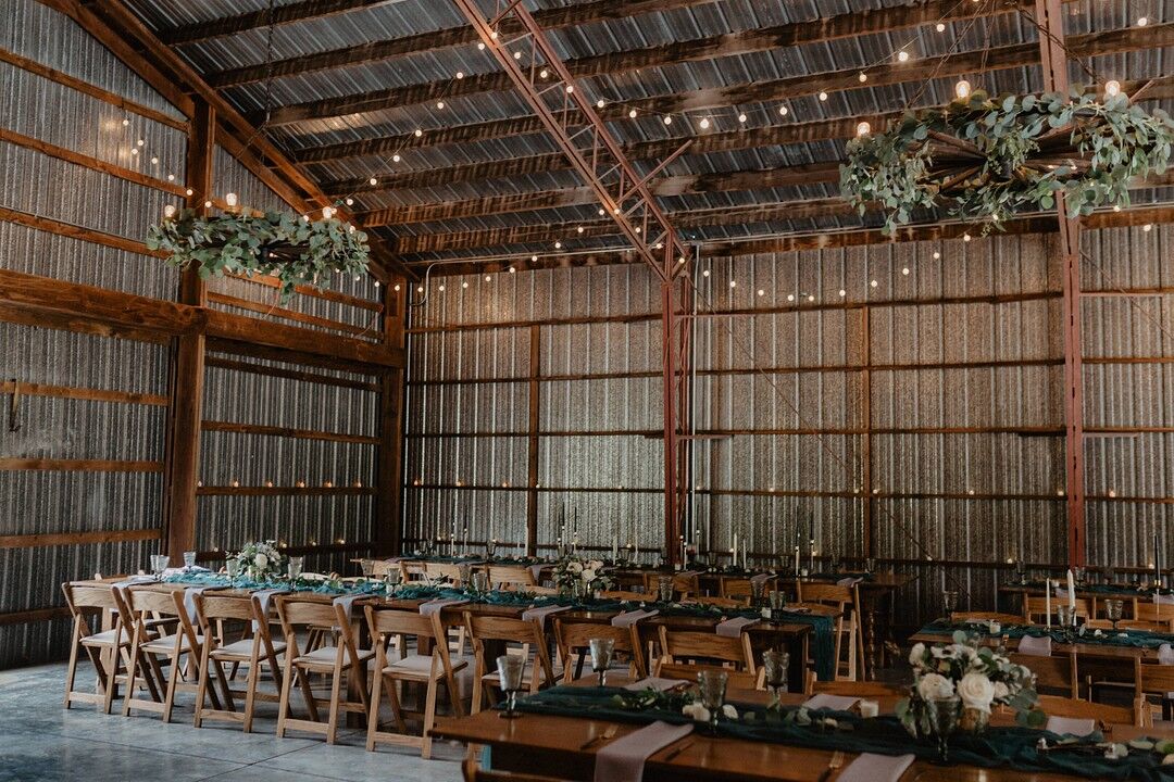 Rustic Barn Reception with Hanging Greenery and String Lights