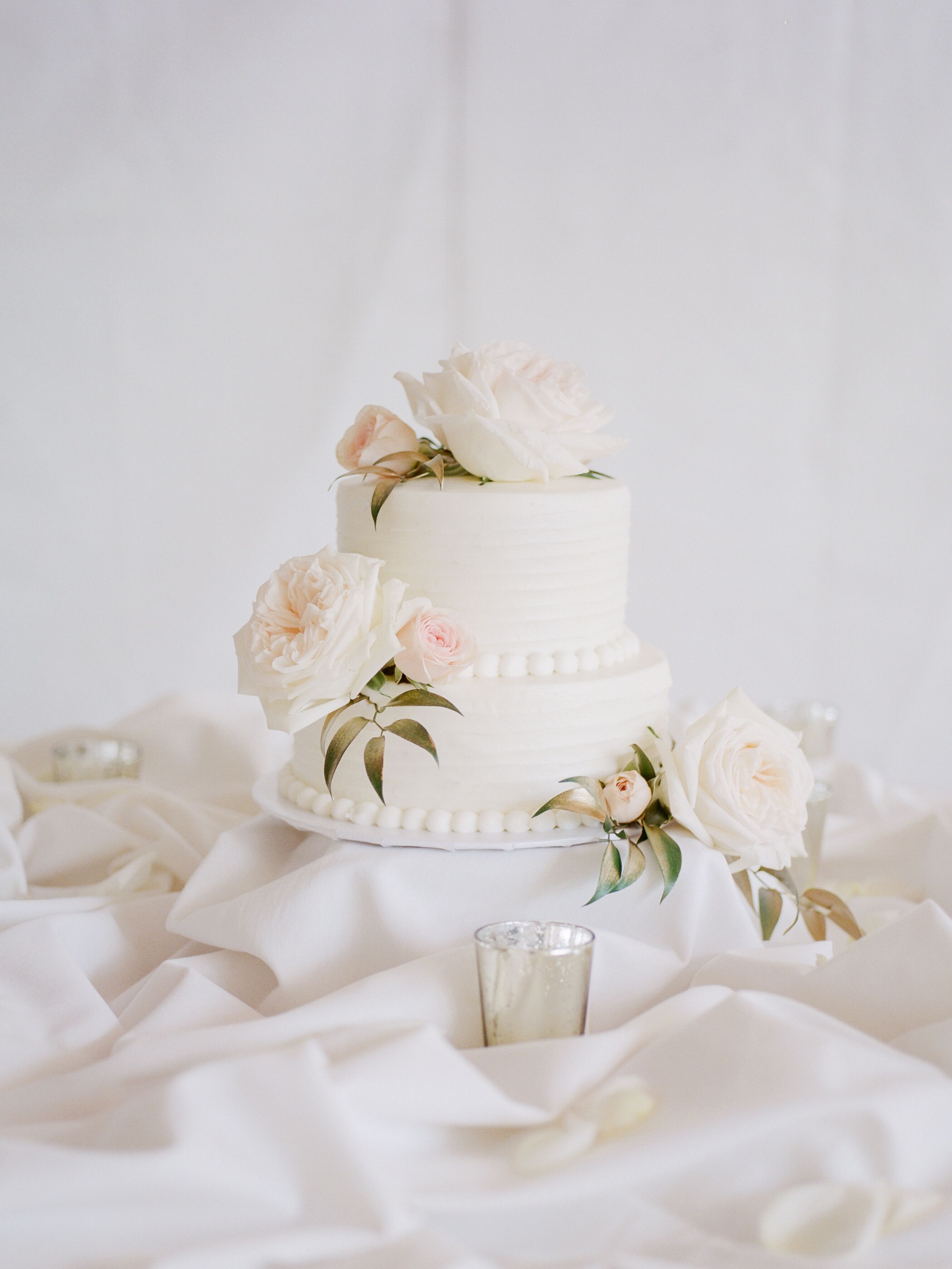 Two Tier White Wedding Cake With Lush Roses