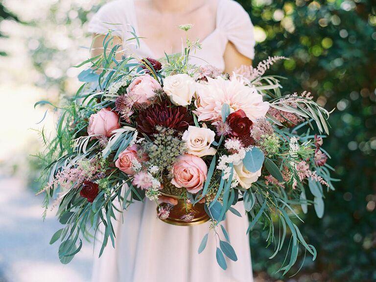 Overgrown bridal bouquet with red, pink and blush flowers