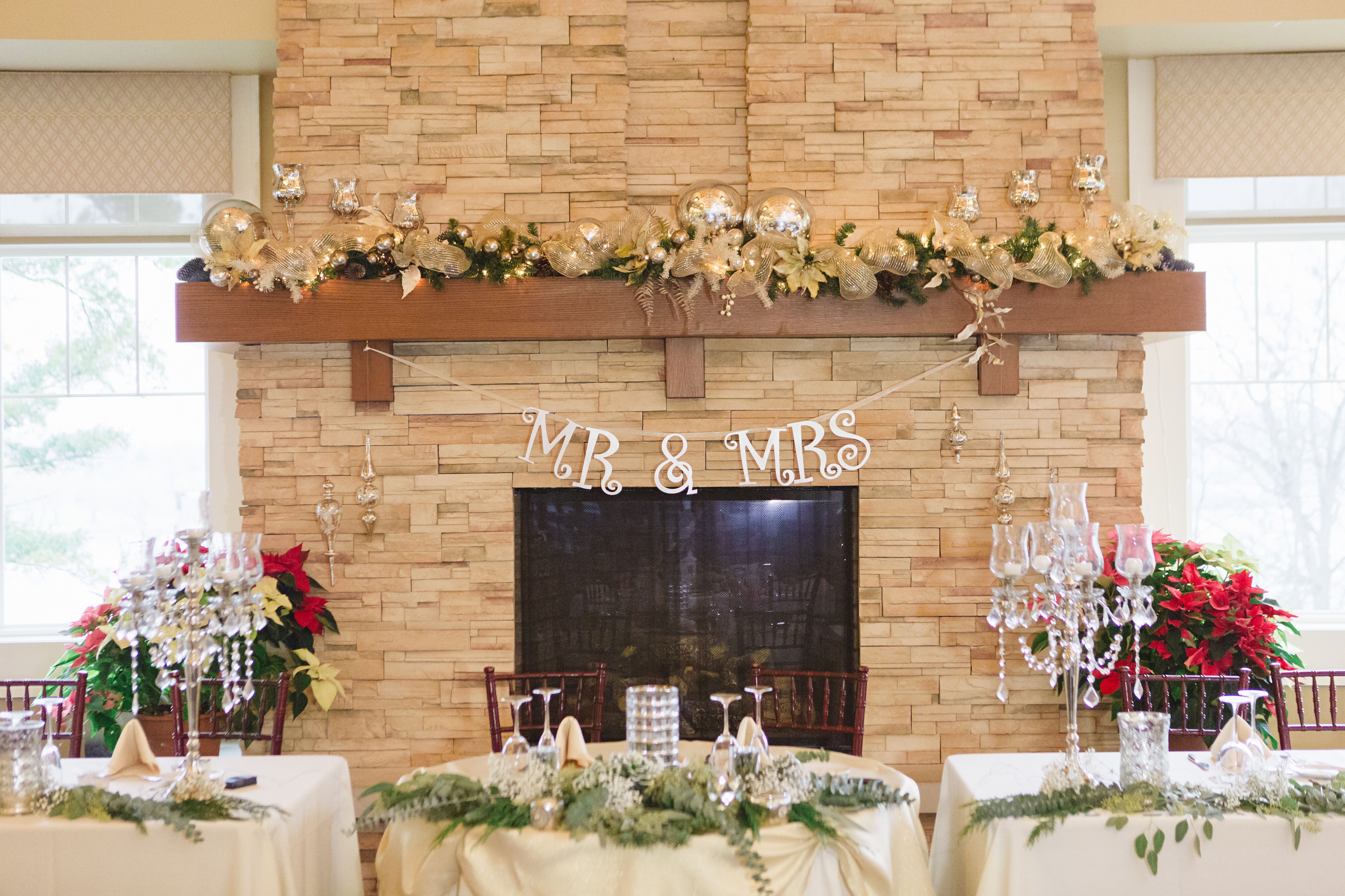 A Rustic Reception Fireplace with Wedding Banner