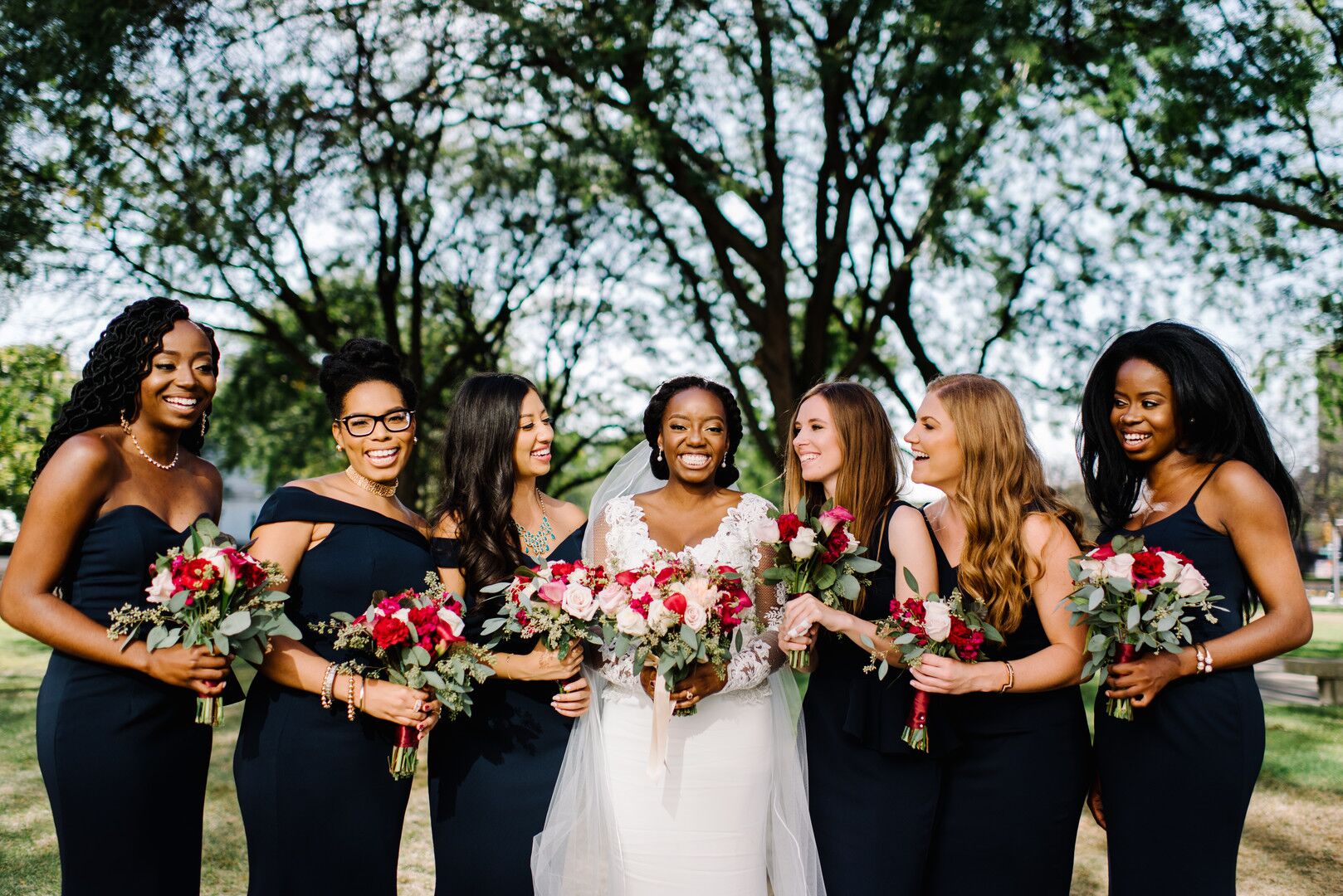 Classic Bride and Modern Bridesmaids Wearing Black Gowns