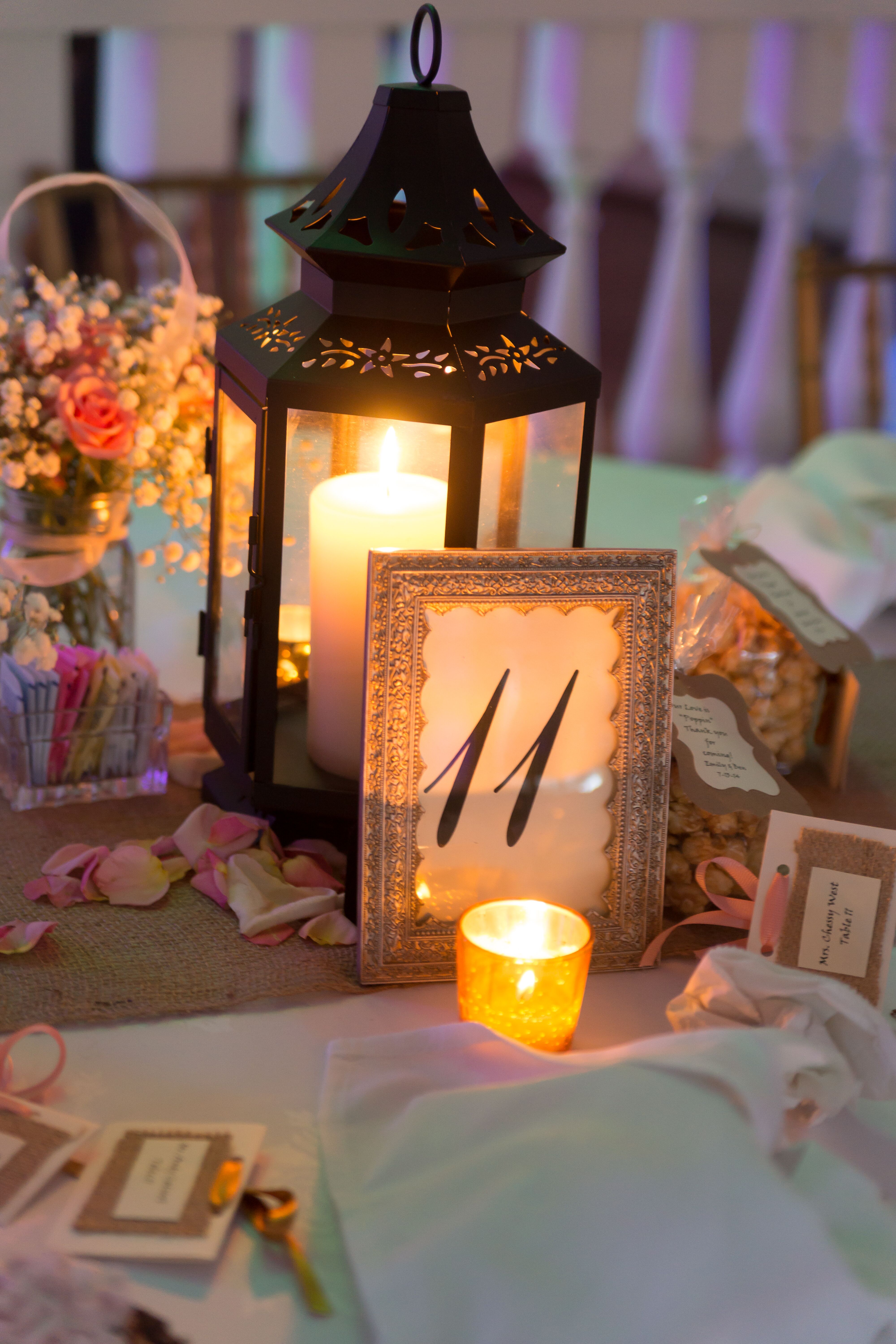 Iron Lantern Centerpieces With Candles And Coral Roses