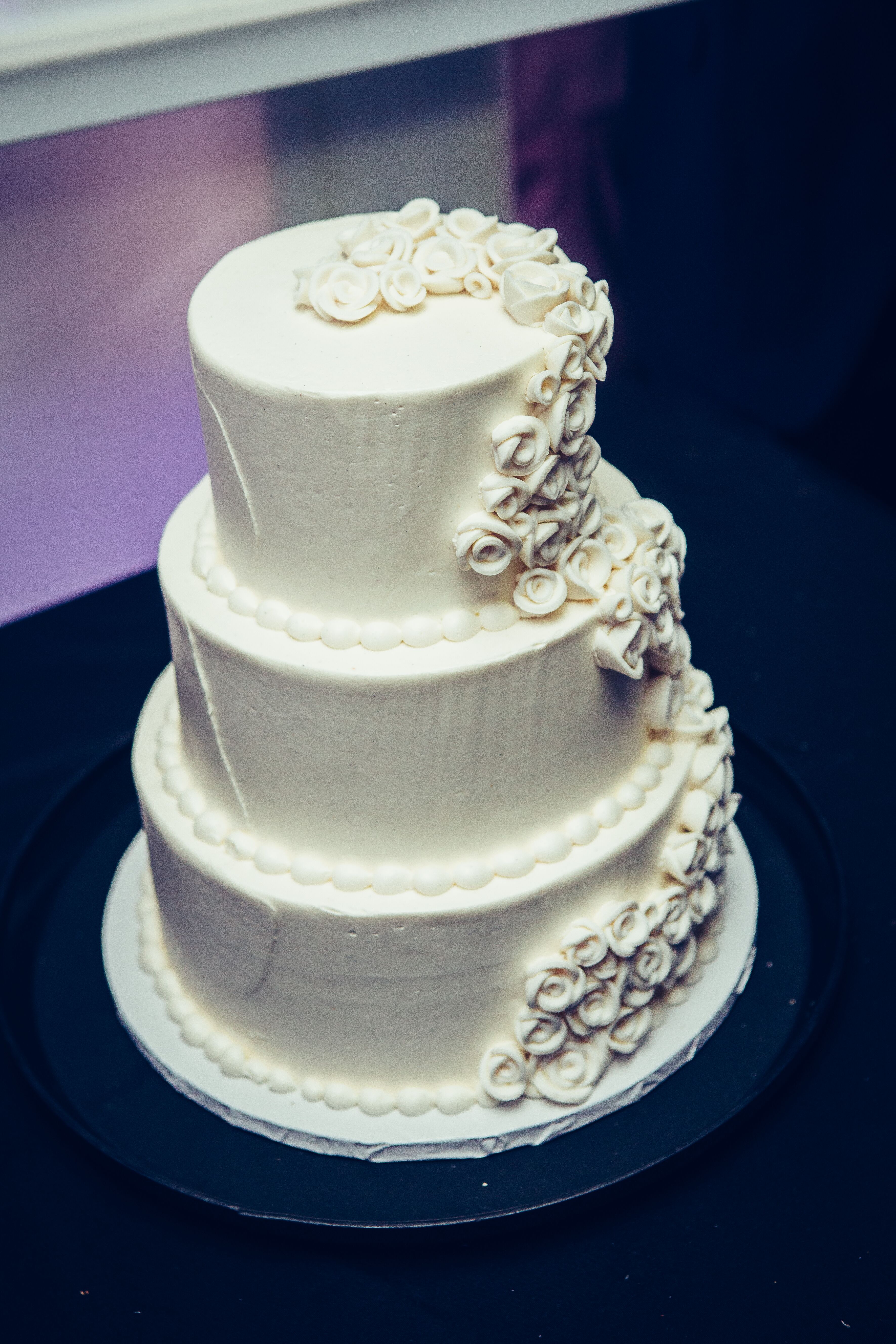 three-tiered-wedding-cake-with-buttercream-rose-decorations