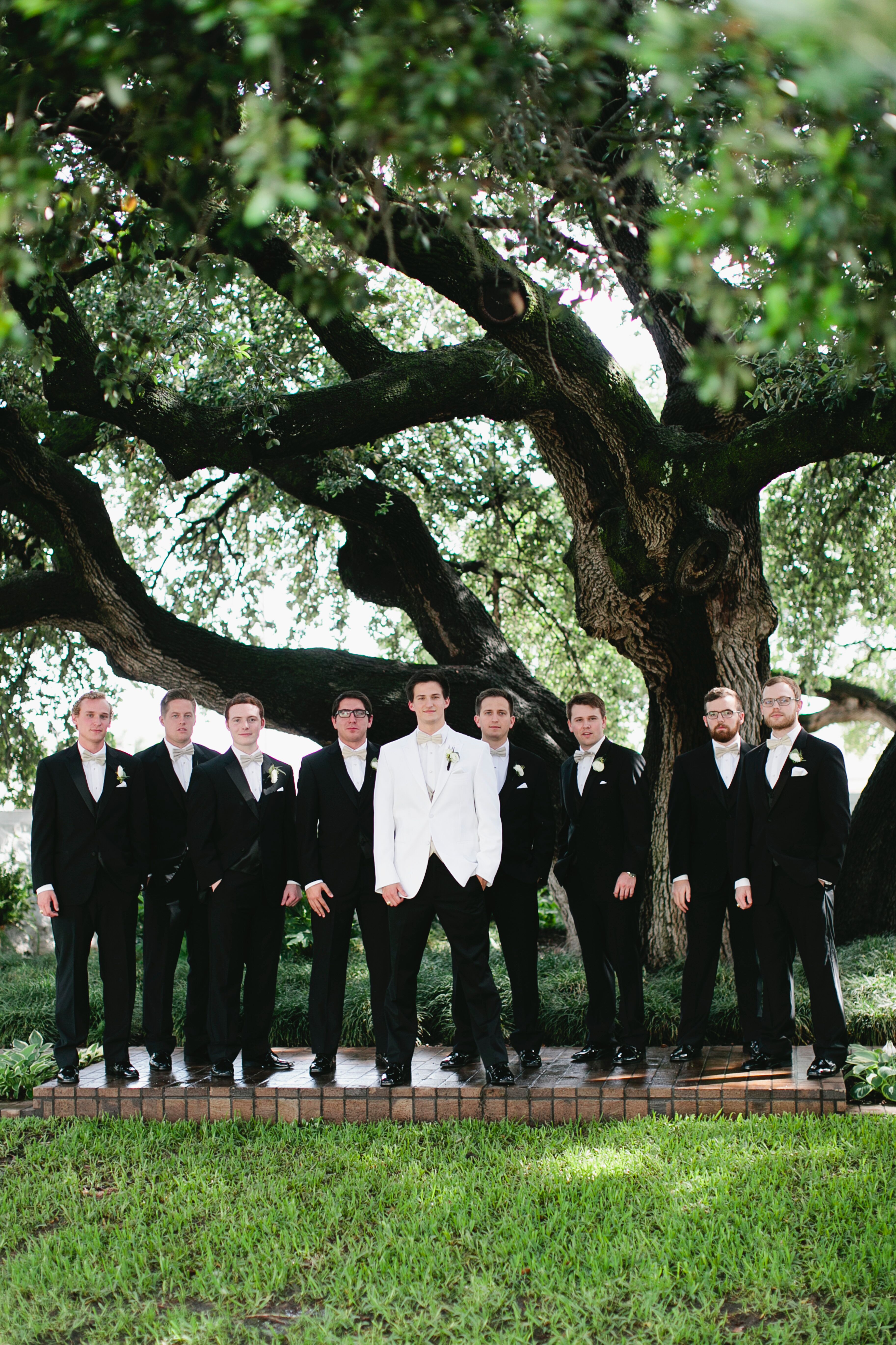 Groomsmen in Black Tuxedos with Red Bow Ties