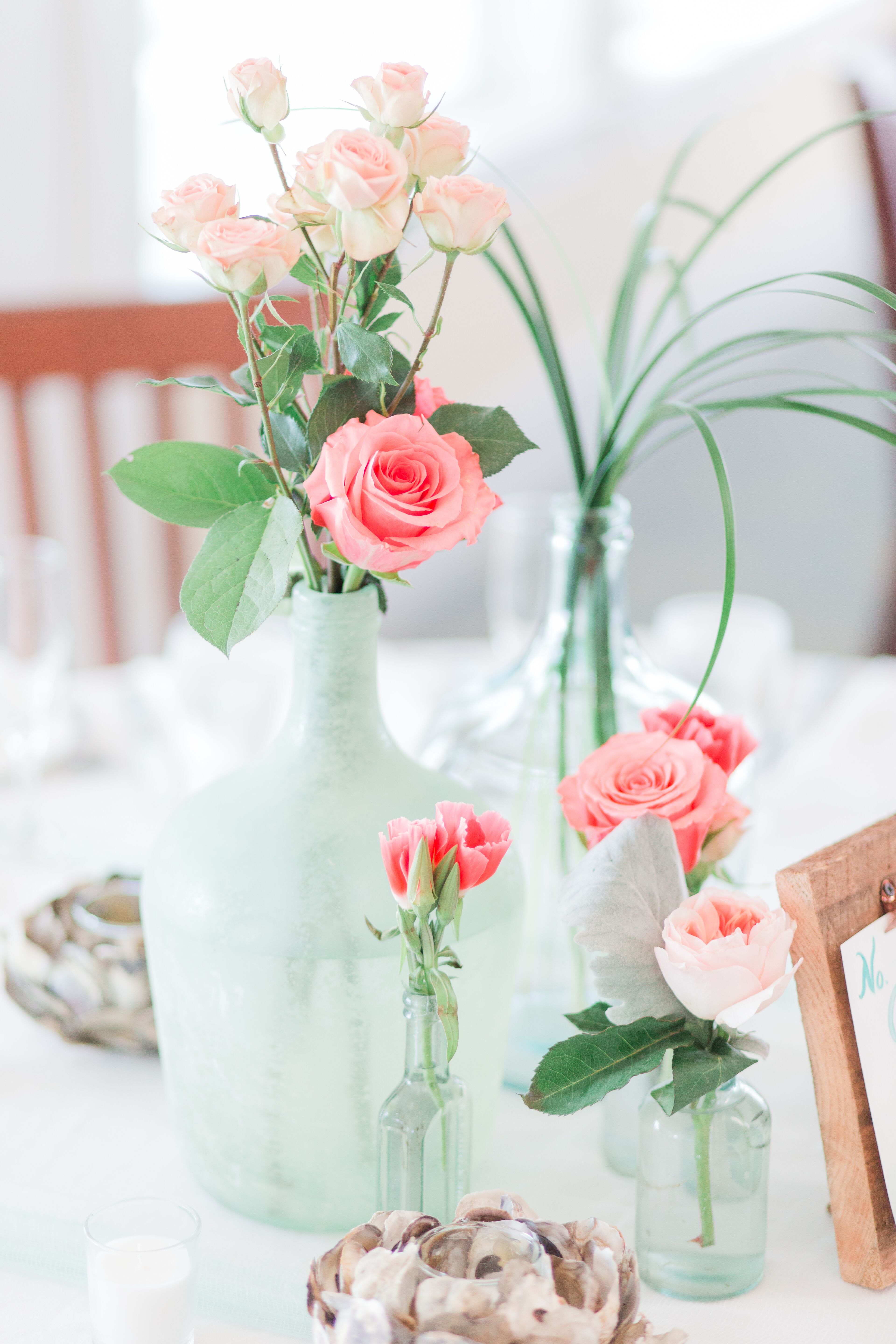 Coral Rose Centerpiece in Blue Sea Glass Vase 9fdbcfce e7a4 11e7 8a2a 0e141a3020b2