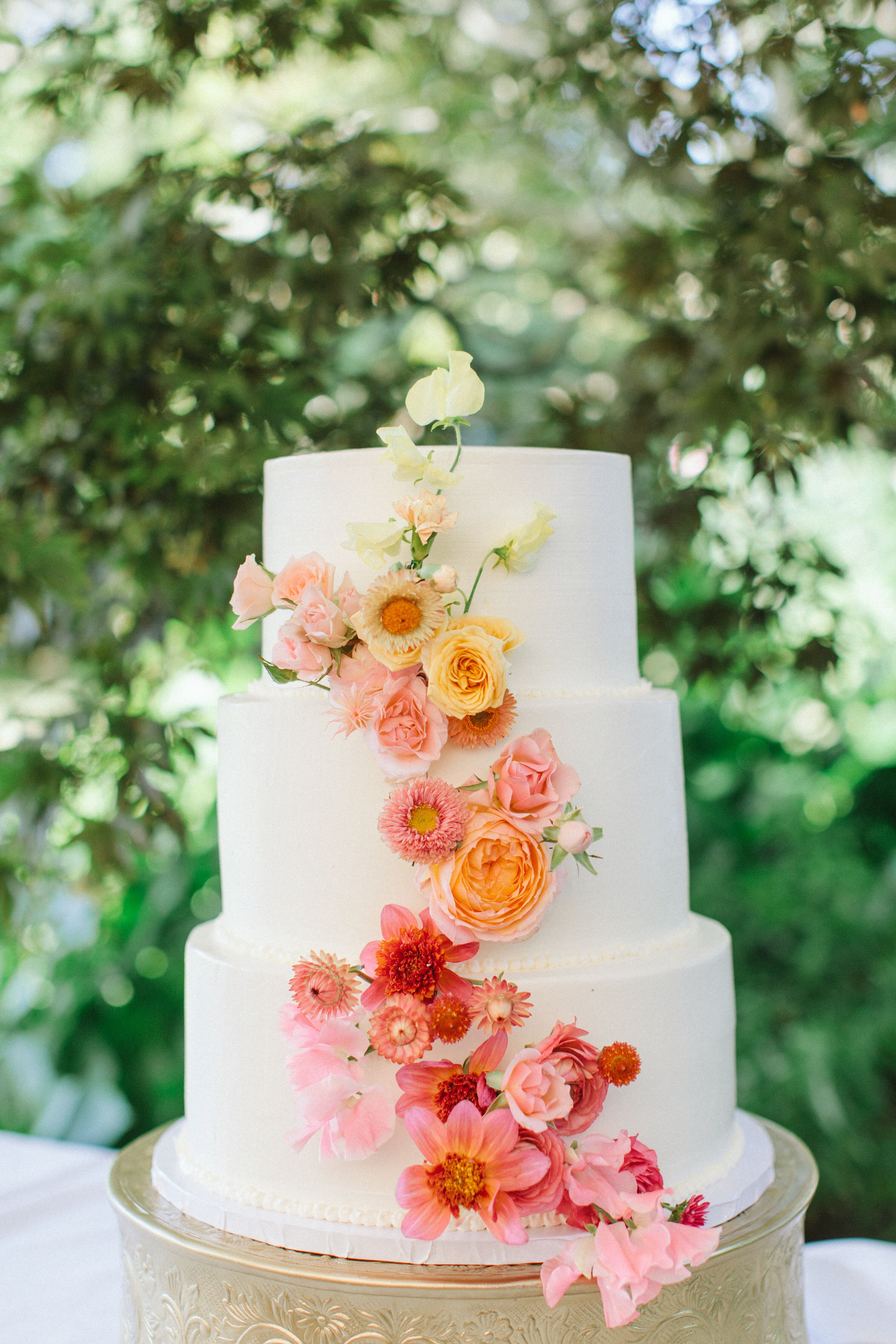 Three-Tier Wedding Cake with Cascade of Colorful Flowers