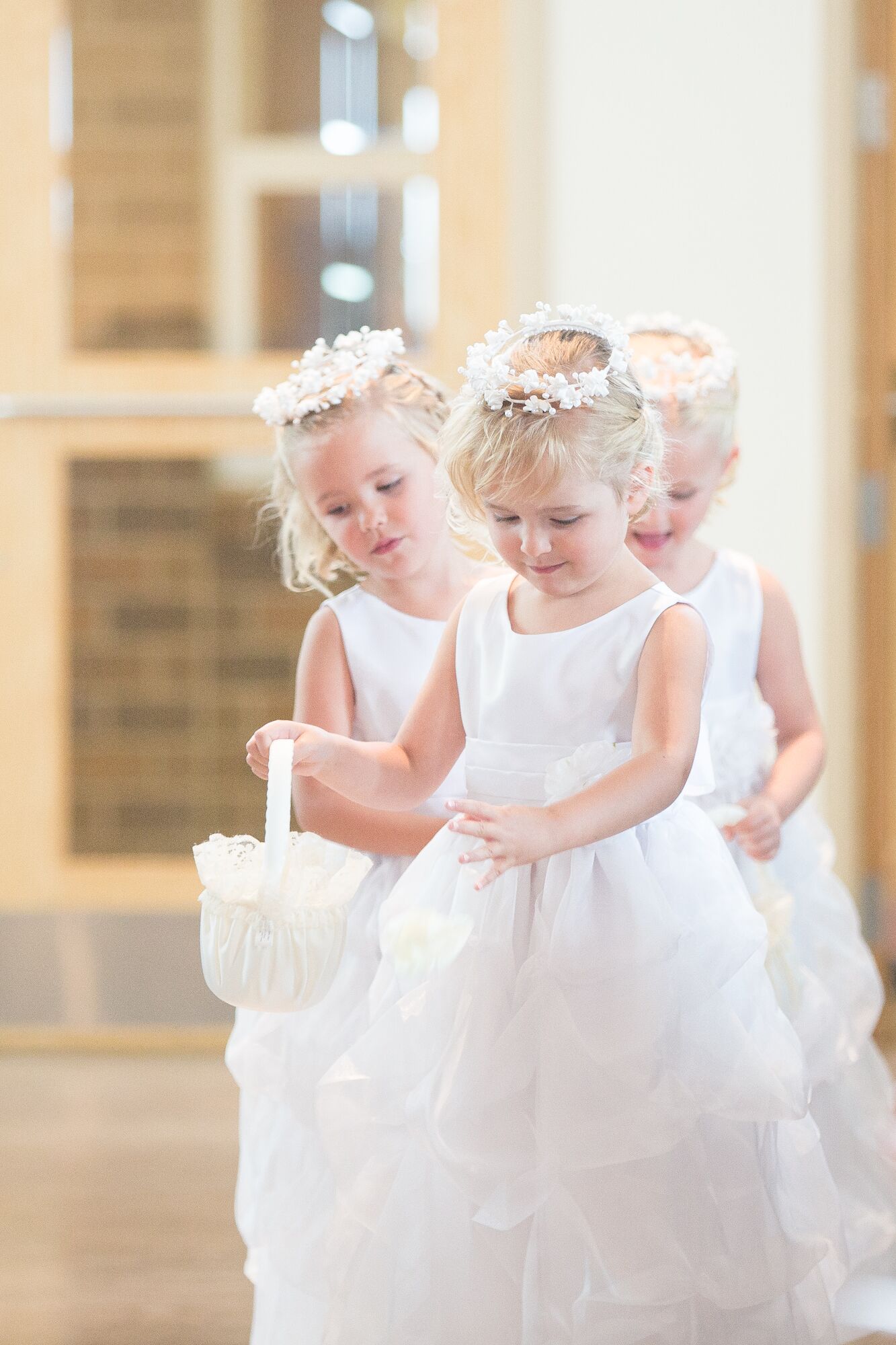 Three Flower Girls With White Flower Crowns