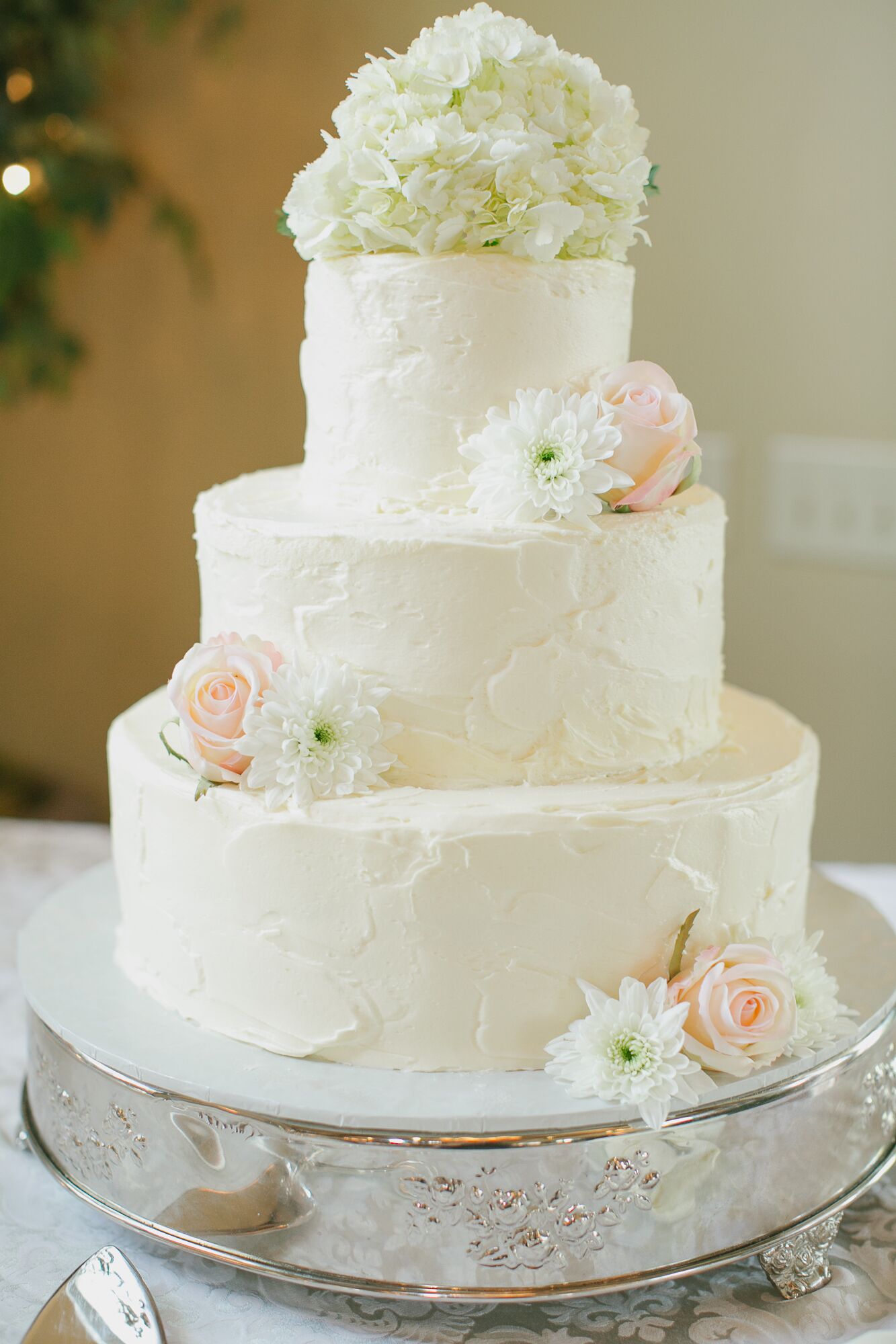 Simple All-White Wedding Cake With Fresh Flowers