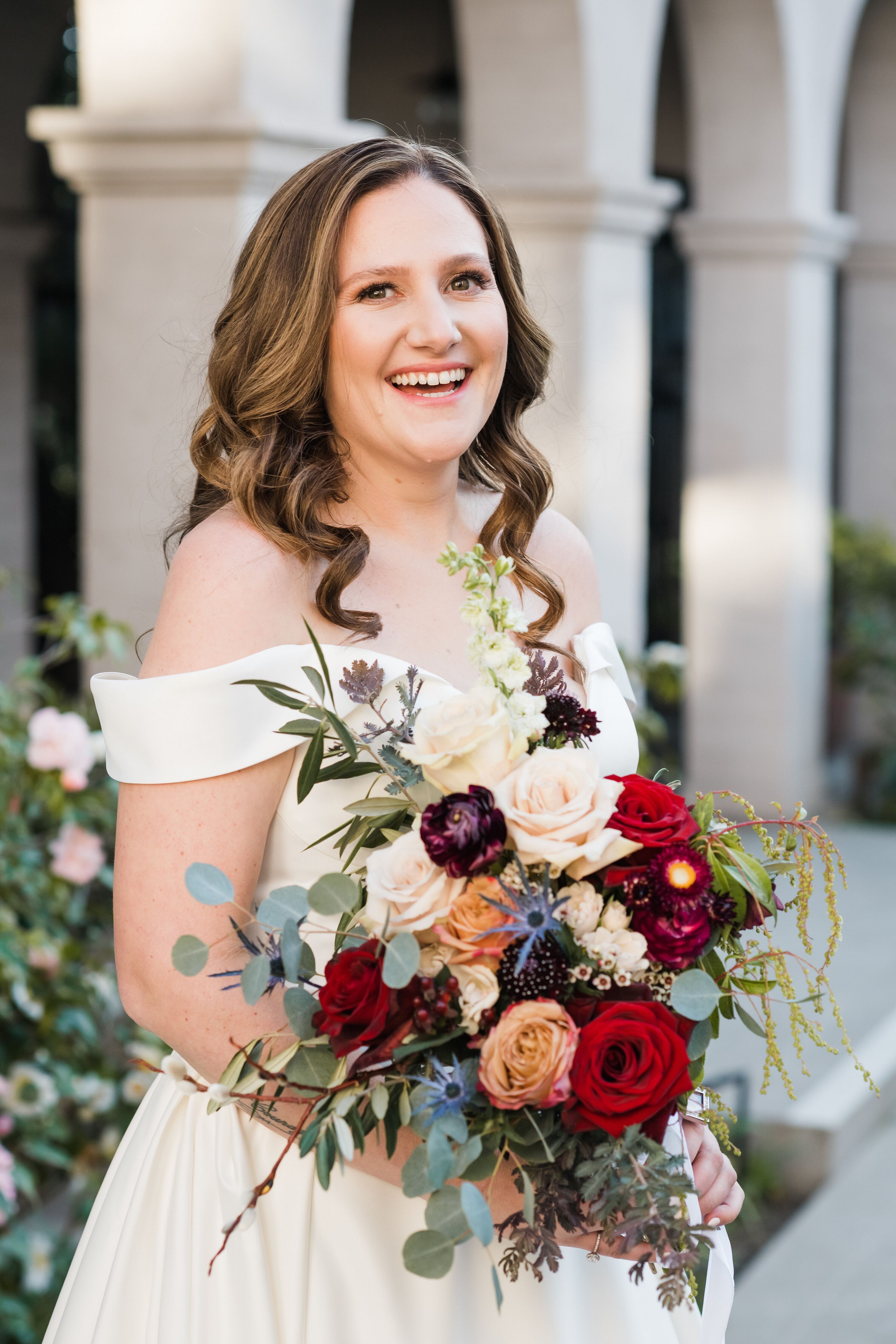 bride-with-loose-curls-and-off-the-shoulder-wedding-dress