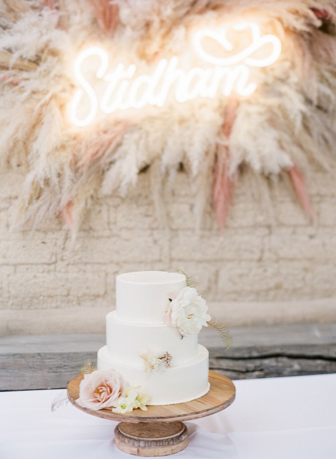 Rustic Tiered Cake with Flowers and Wood Stand