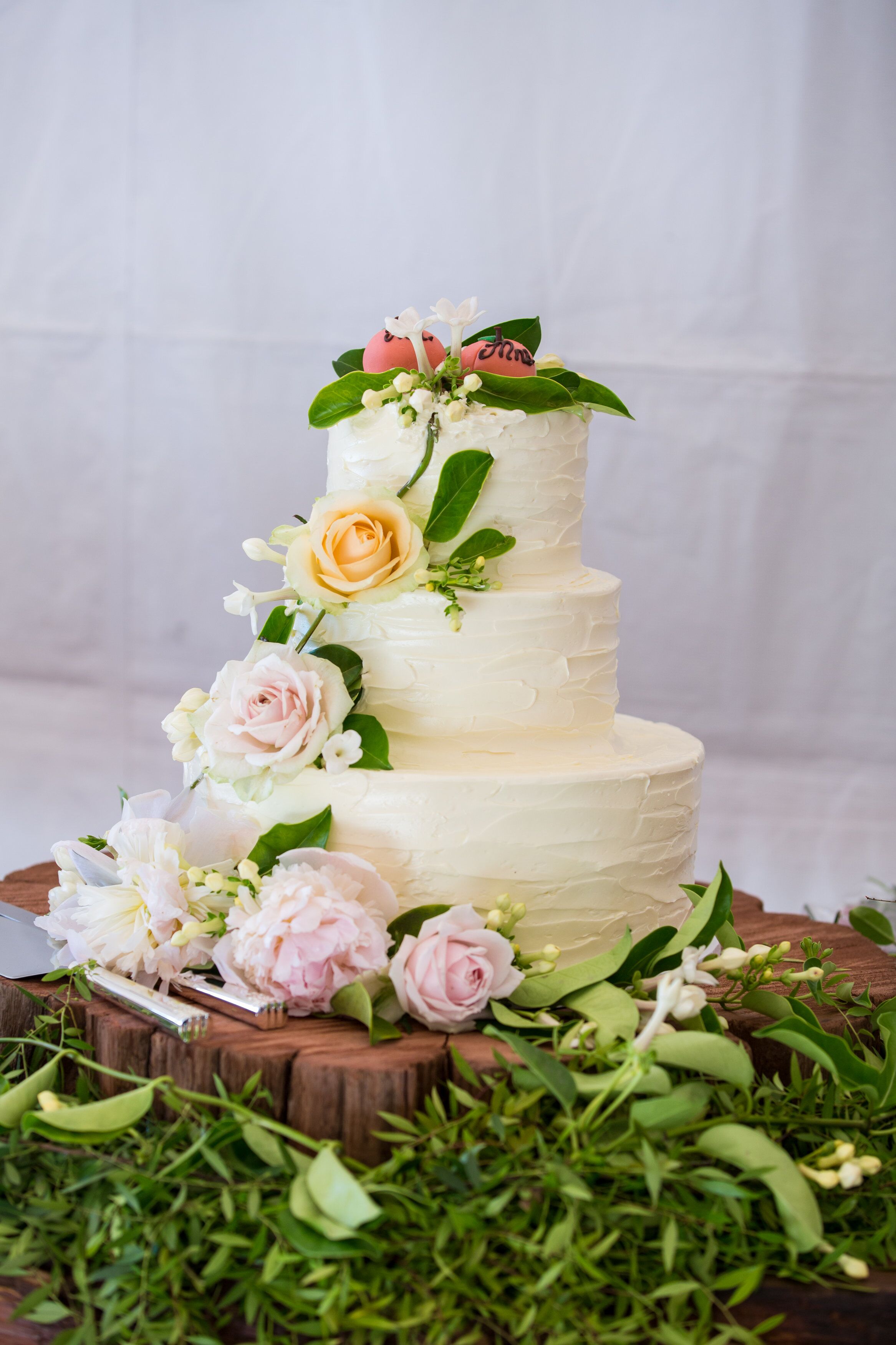 Three Tier Buttercream Wedding Cake With Cascading Flowers 
