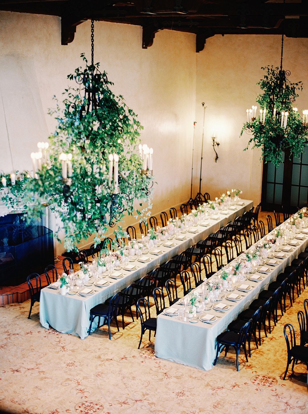 Candle-Lit Farm Tables With Natural Greenery Hanging from the ...
