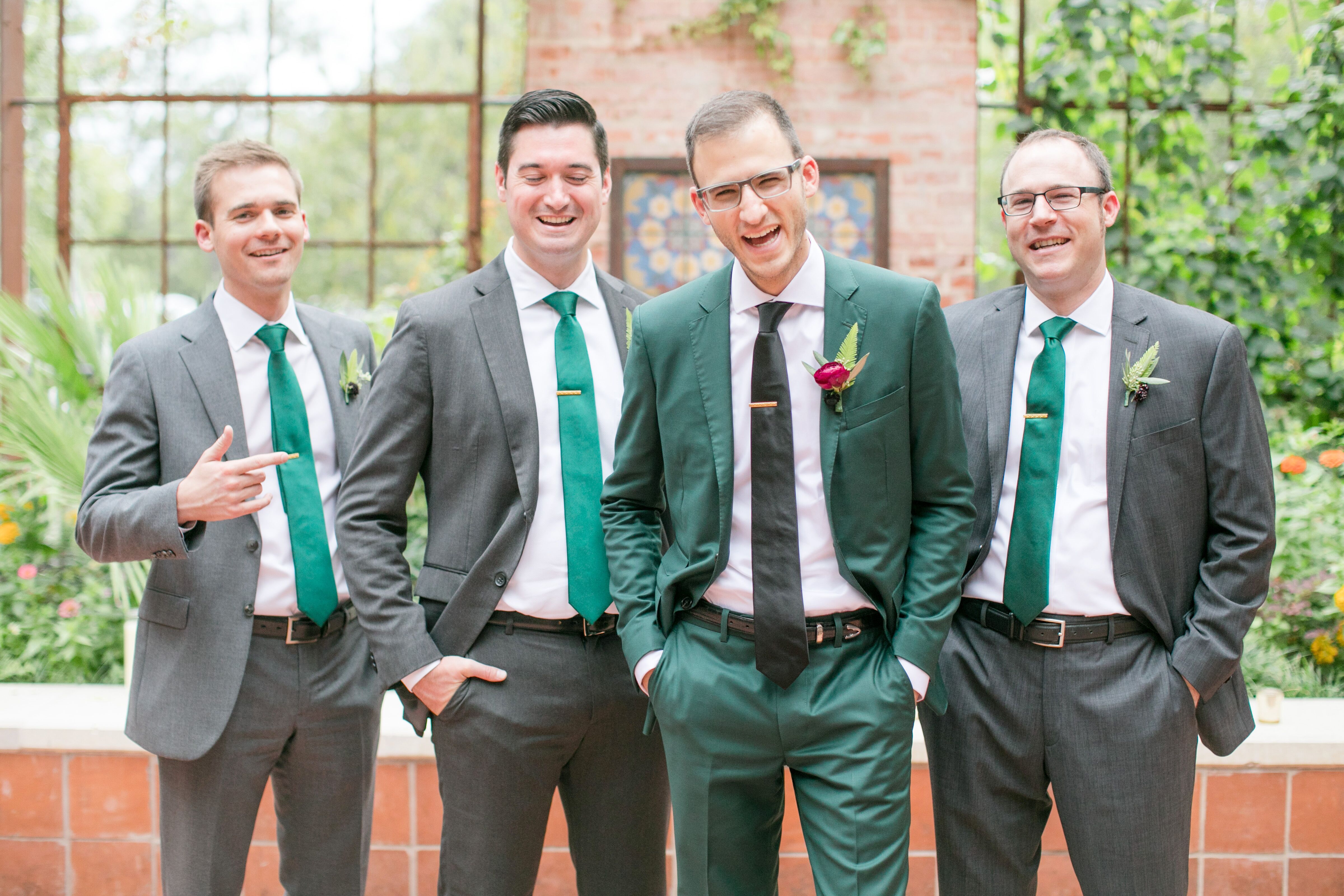 Groom In Emerald Green Suit With Groomsmen In Grey Suits