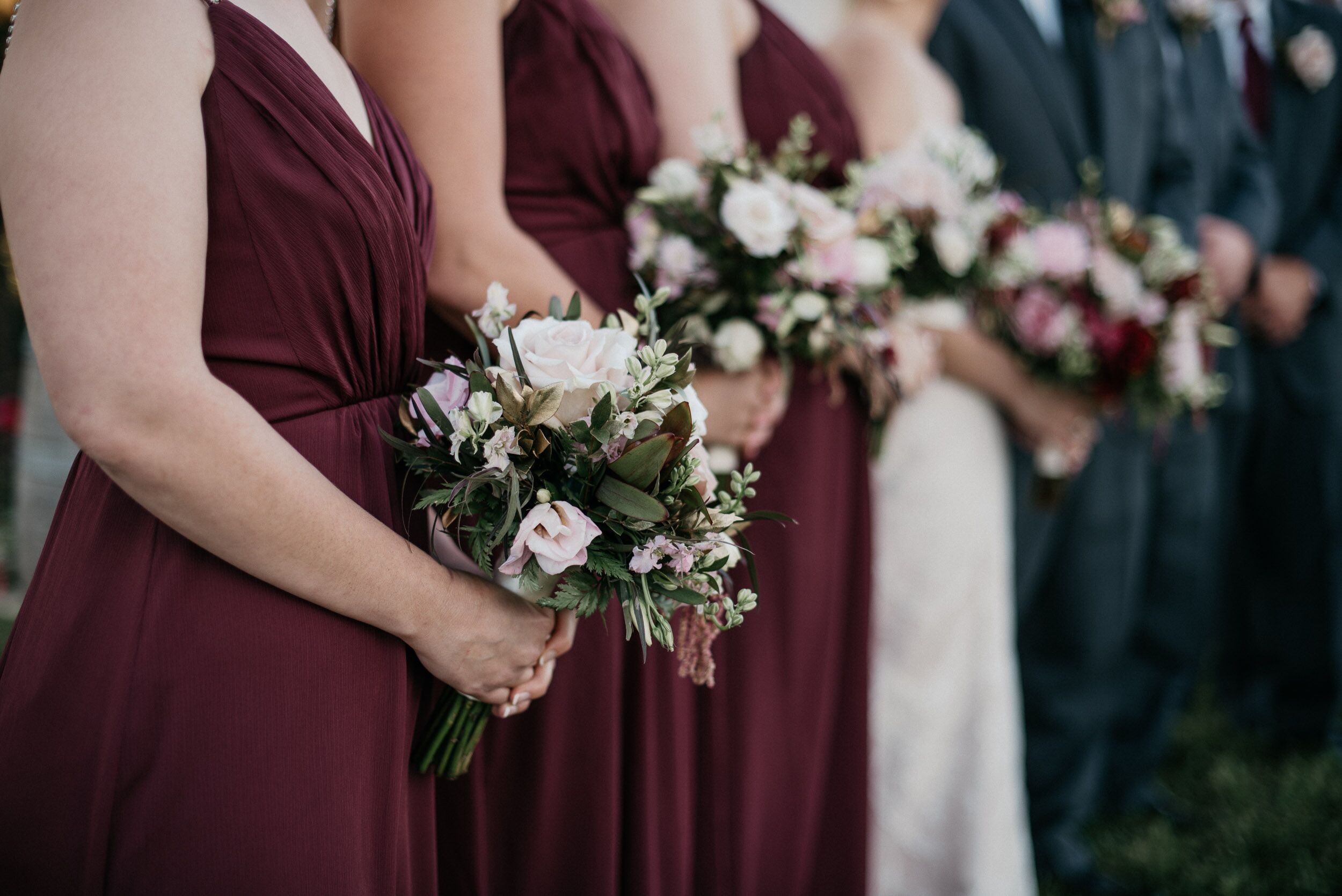 blush wedding dress with burgundy bridesmaids