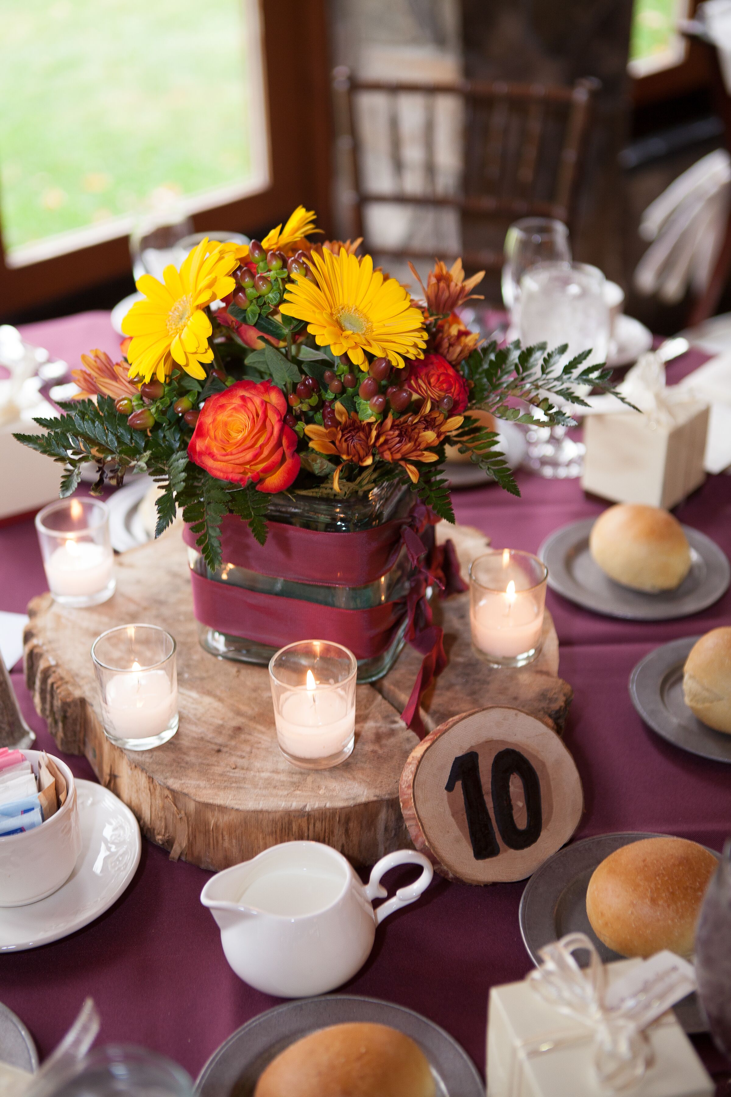 Centerpiece And Candles On Wooden Slab