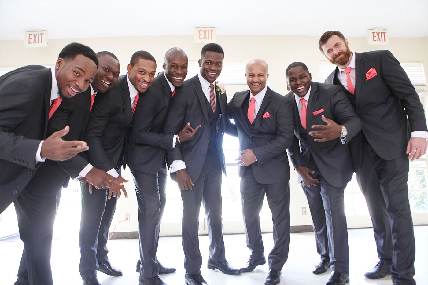 Groomsmen In Black Tuxedos With Coral Ties