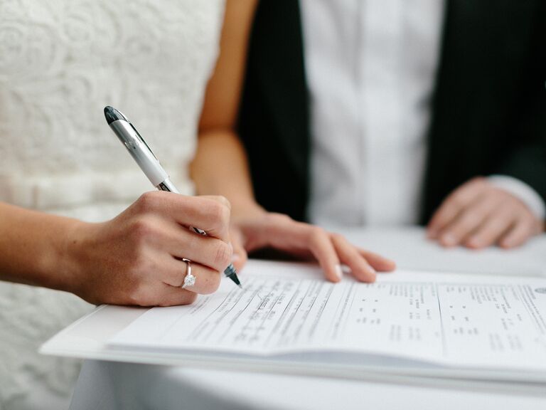 Bride signing marriage license