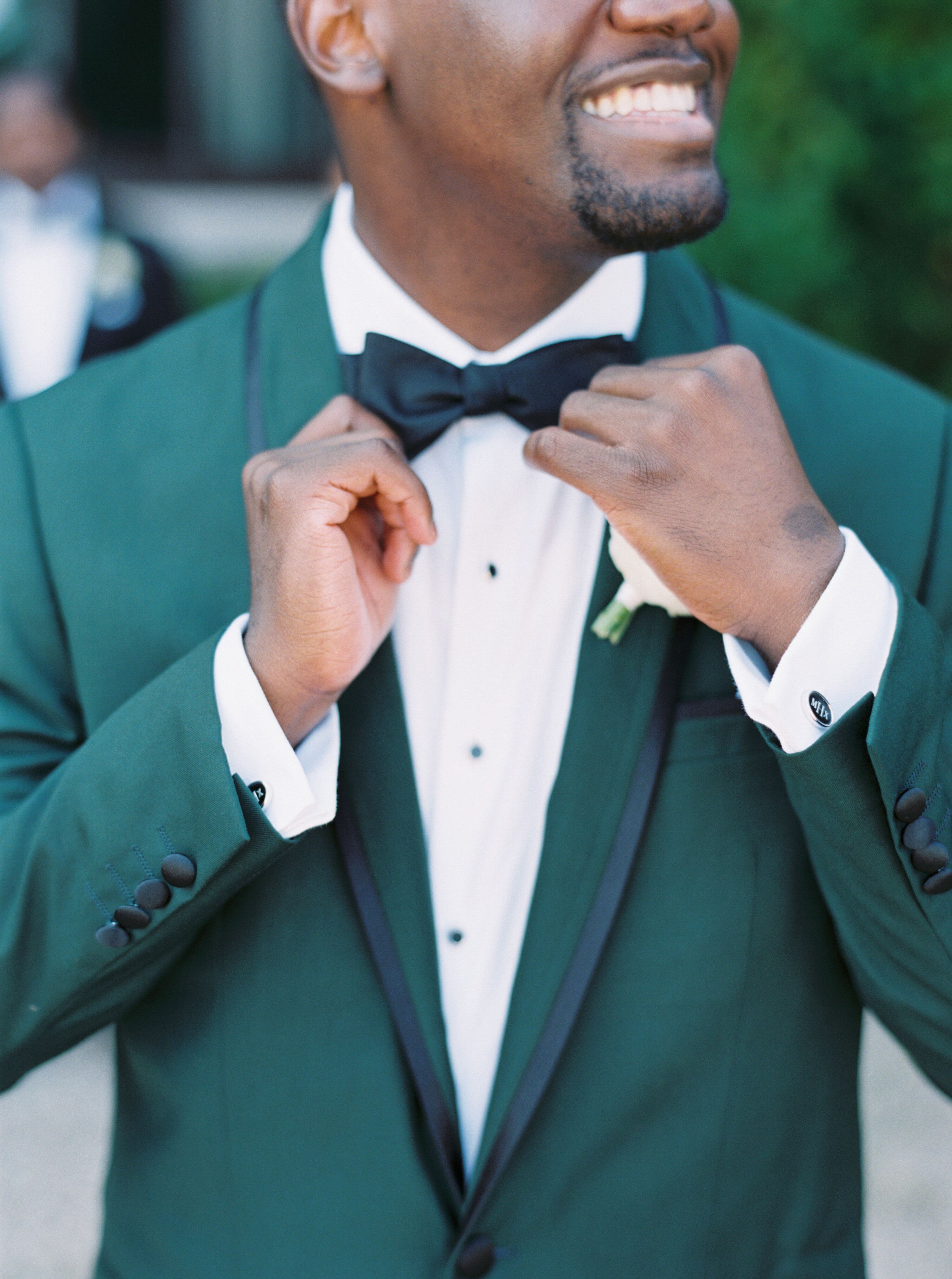 Groom in Green Tuxedo With Black Bowtie