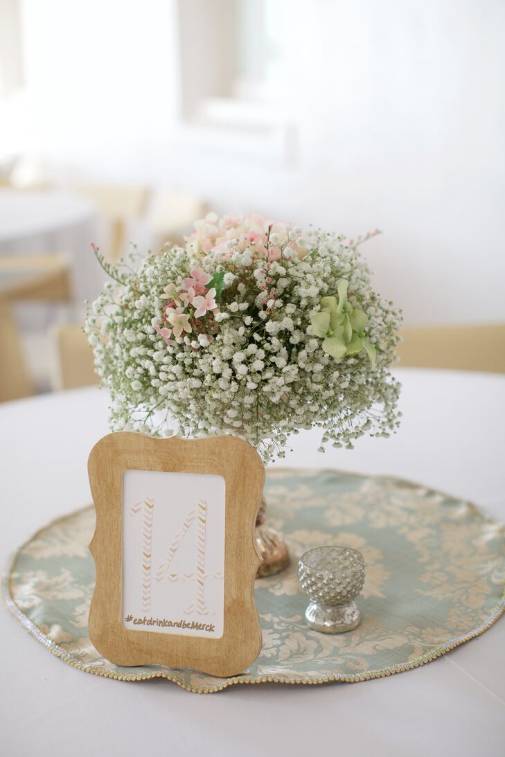 Baby's breath centerpieces with table numbers in wooden frames and wedding hashtag