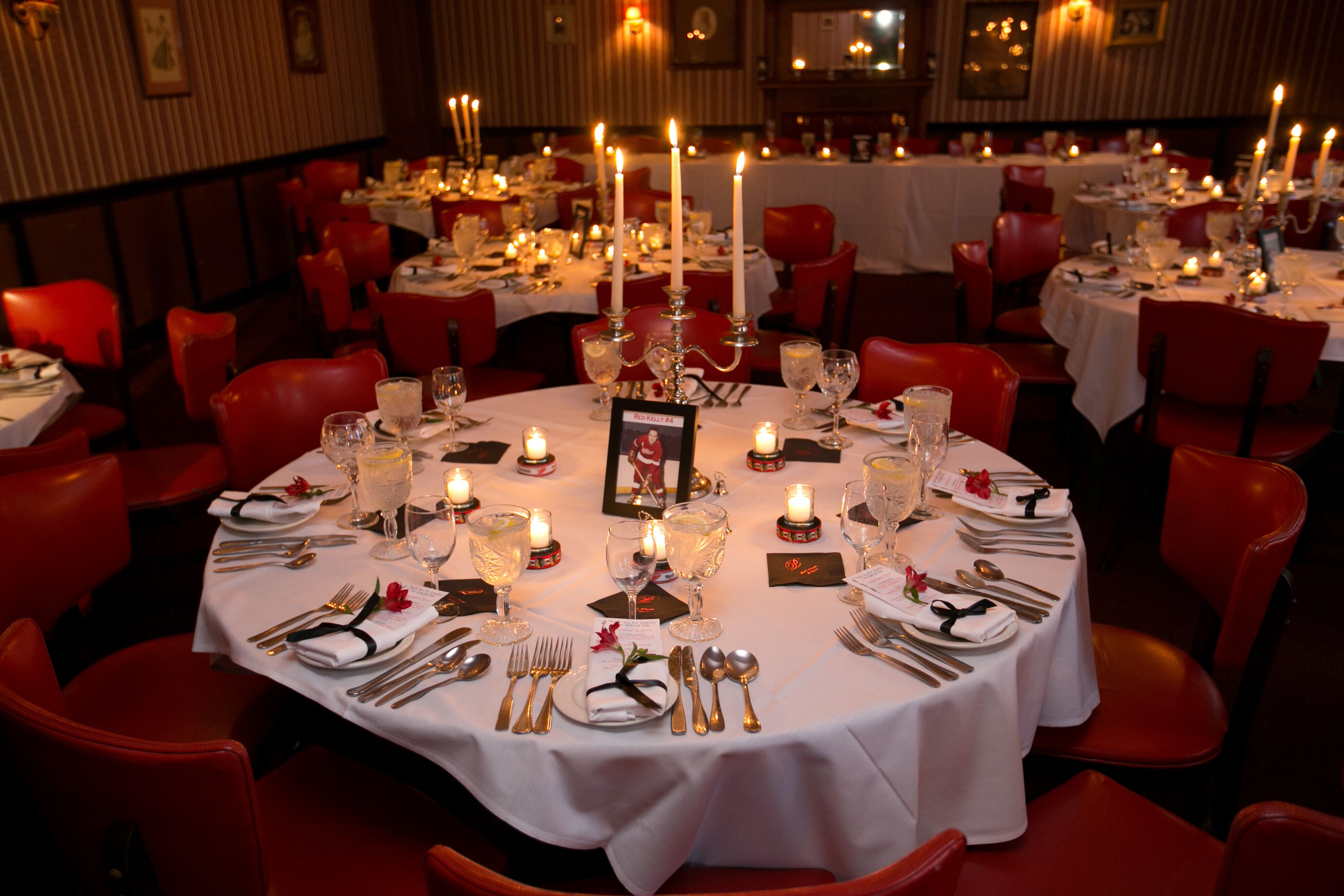 Red and White Round Reception Tables with Candelabras and Hockey Table Numbers