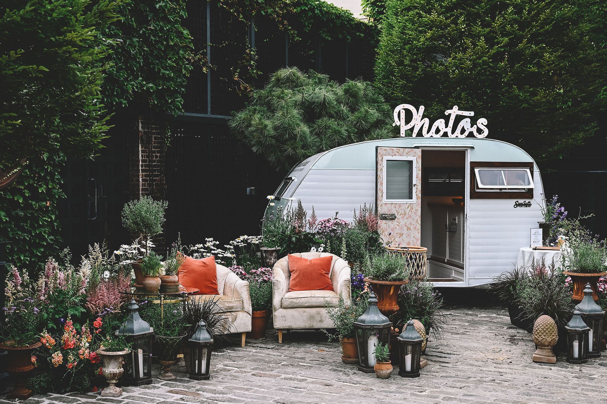 Vintage Trailer Photo Booth, Chairs and Potted Plants, Flowers With ...