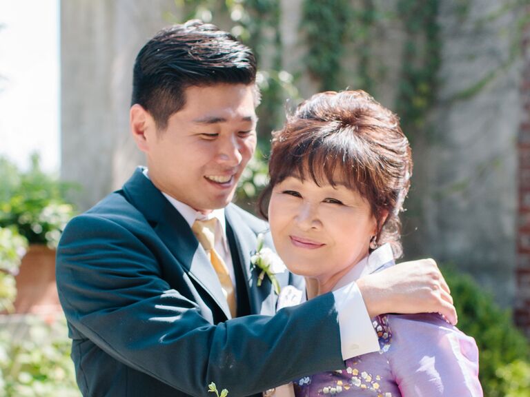 Groom hugging his mother on wedding day