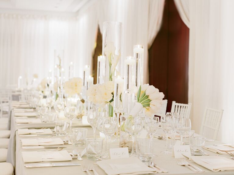 All-white wedding reception with tulips and candles