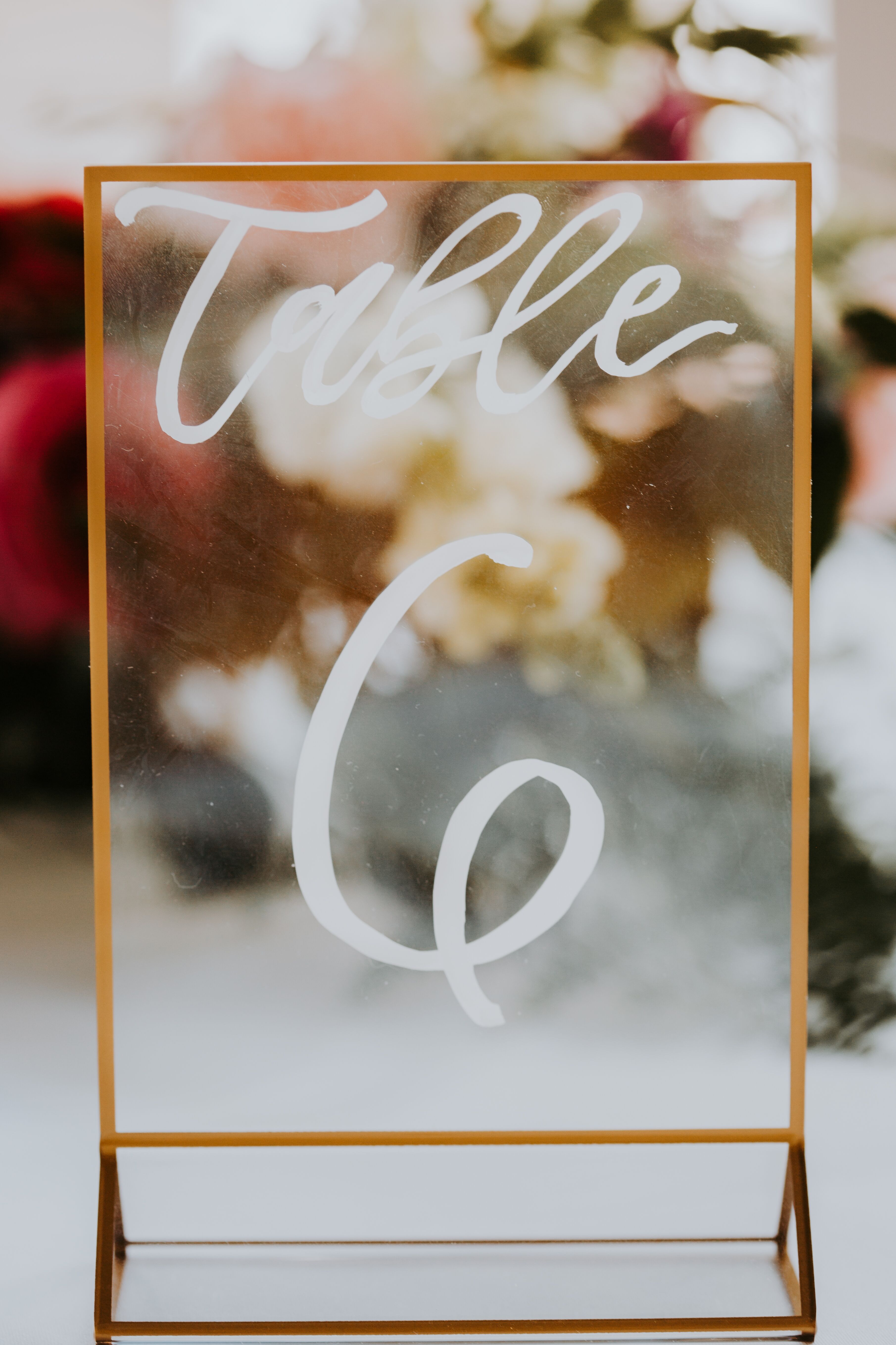 Wedding table number in a gold frame using a gold sharpie on