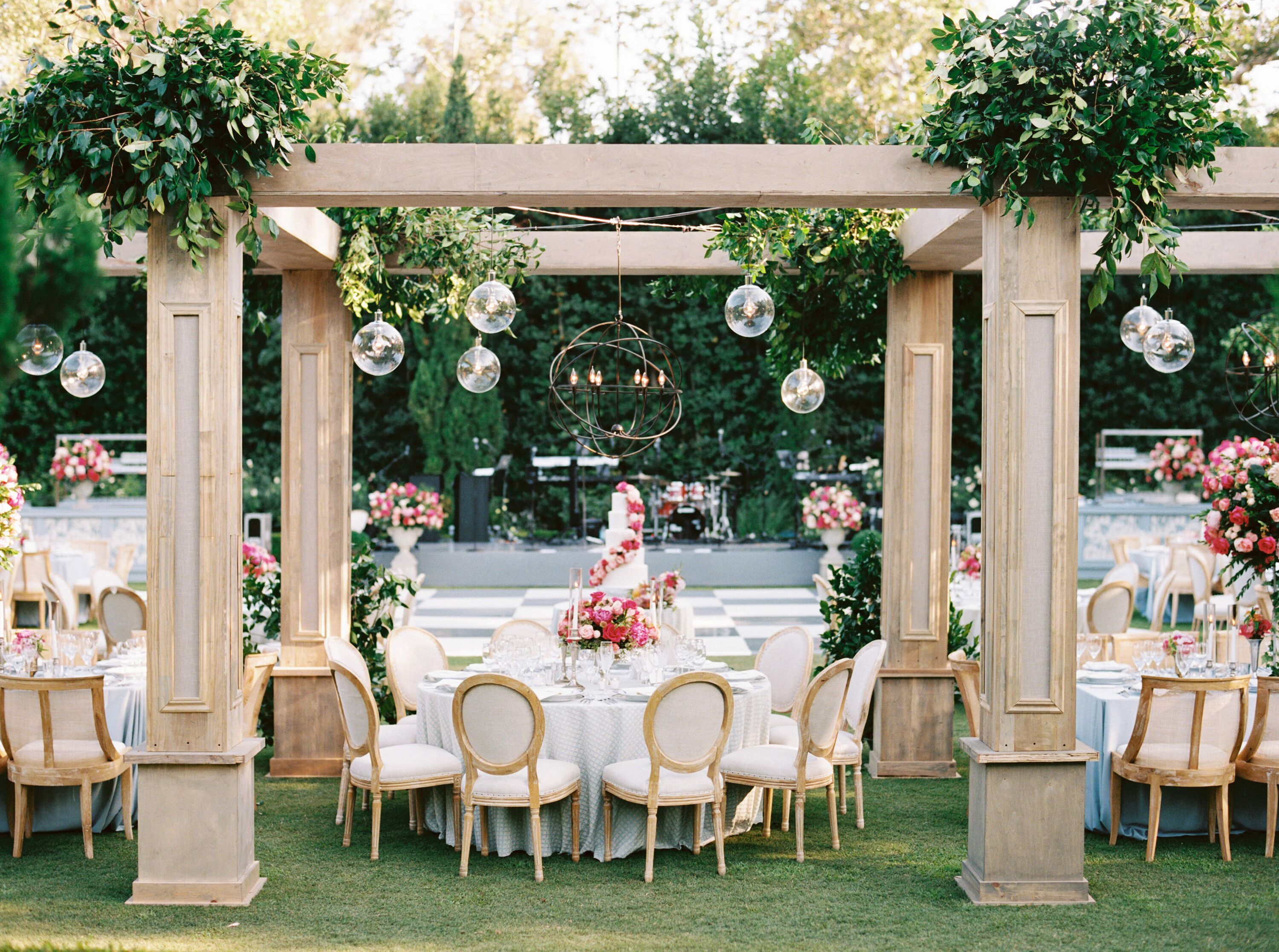 Round Table With Five-Tier Wedding Cake Under Custom Pergolas, Greenery ...